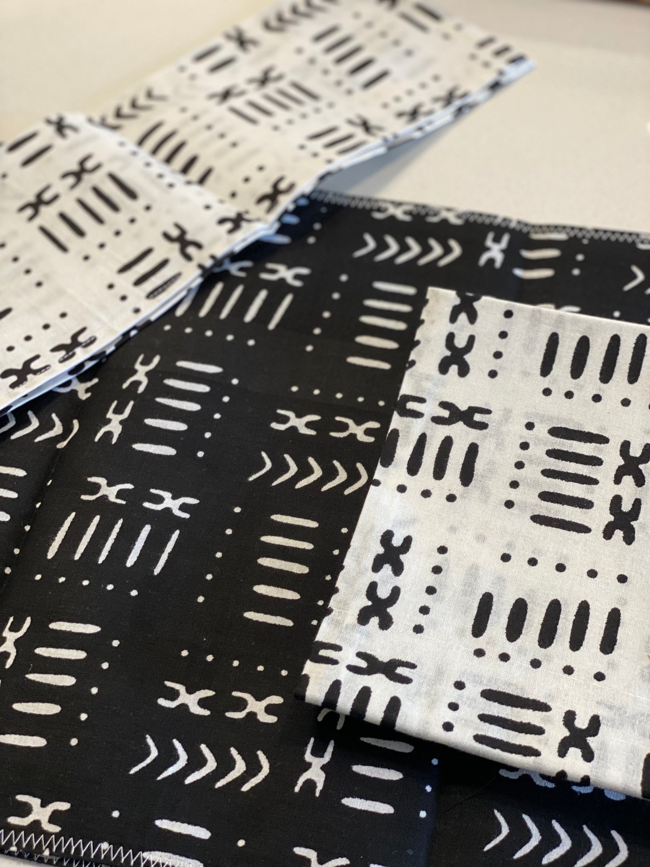 Handmade coffee table runner in black mudcloth featuring authentic wax print, showcasing intricate patterns and textures.