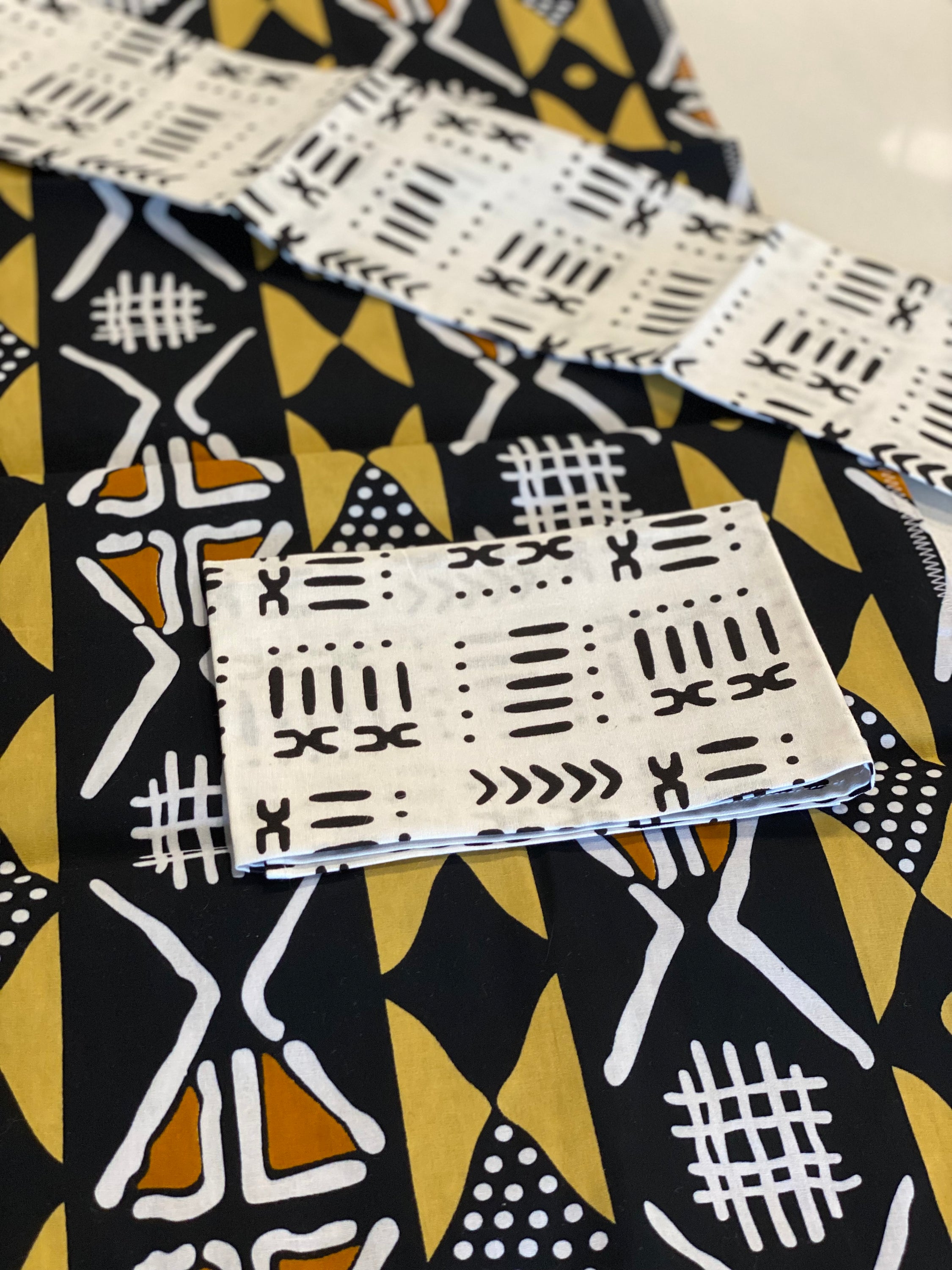 Handmade coffee table runner featuring a unique Brown Bologan wax print design, crafted by Zimbabwean artisans.