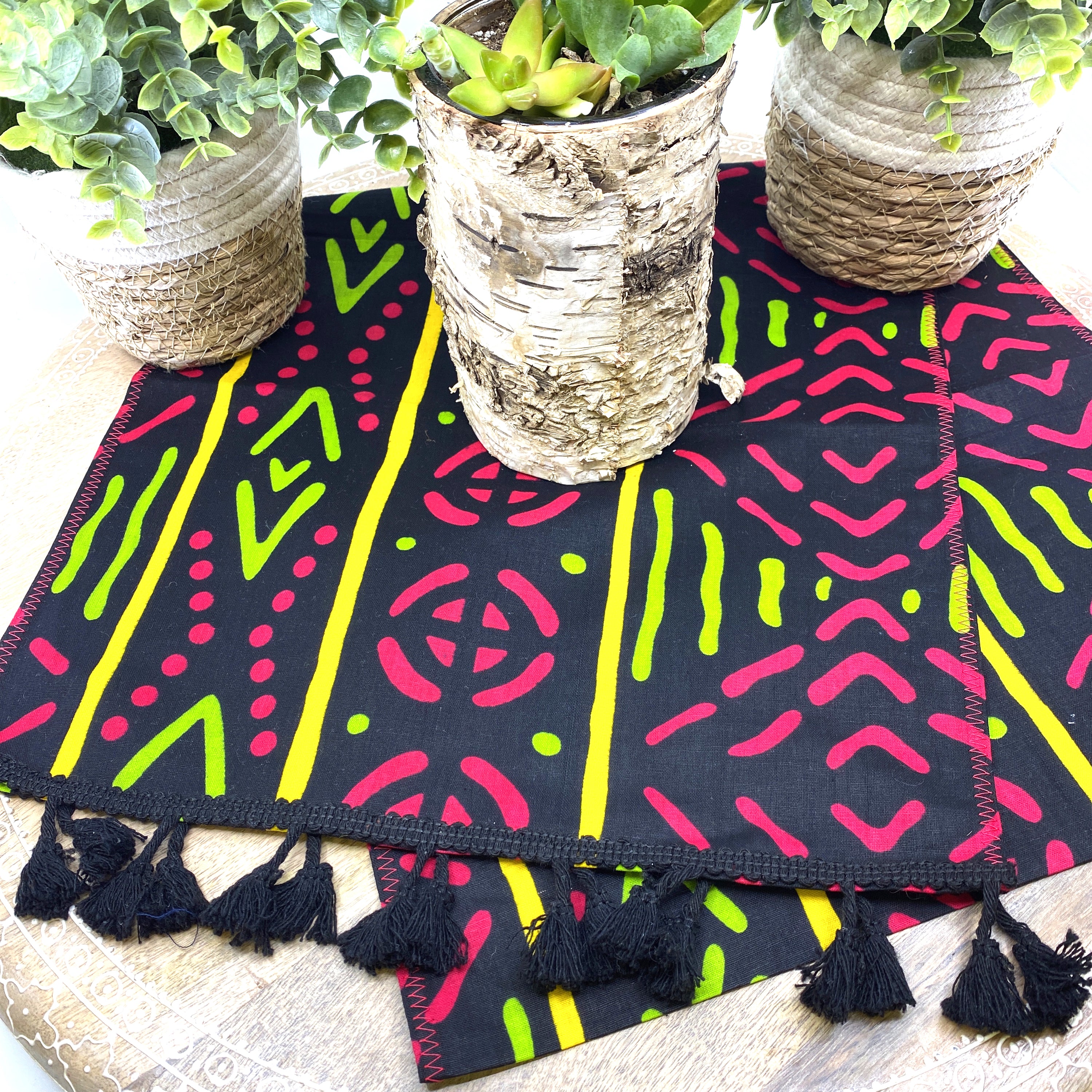 Handmade coffee table runner in pink and green wax print, showcasing vibrant colors and intricate patterns, perfect for home decor.