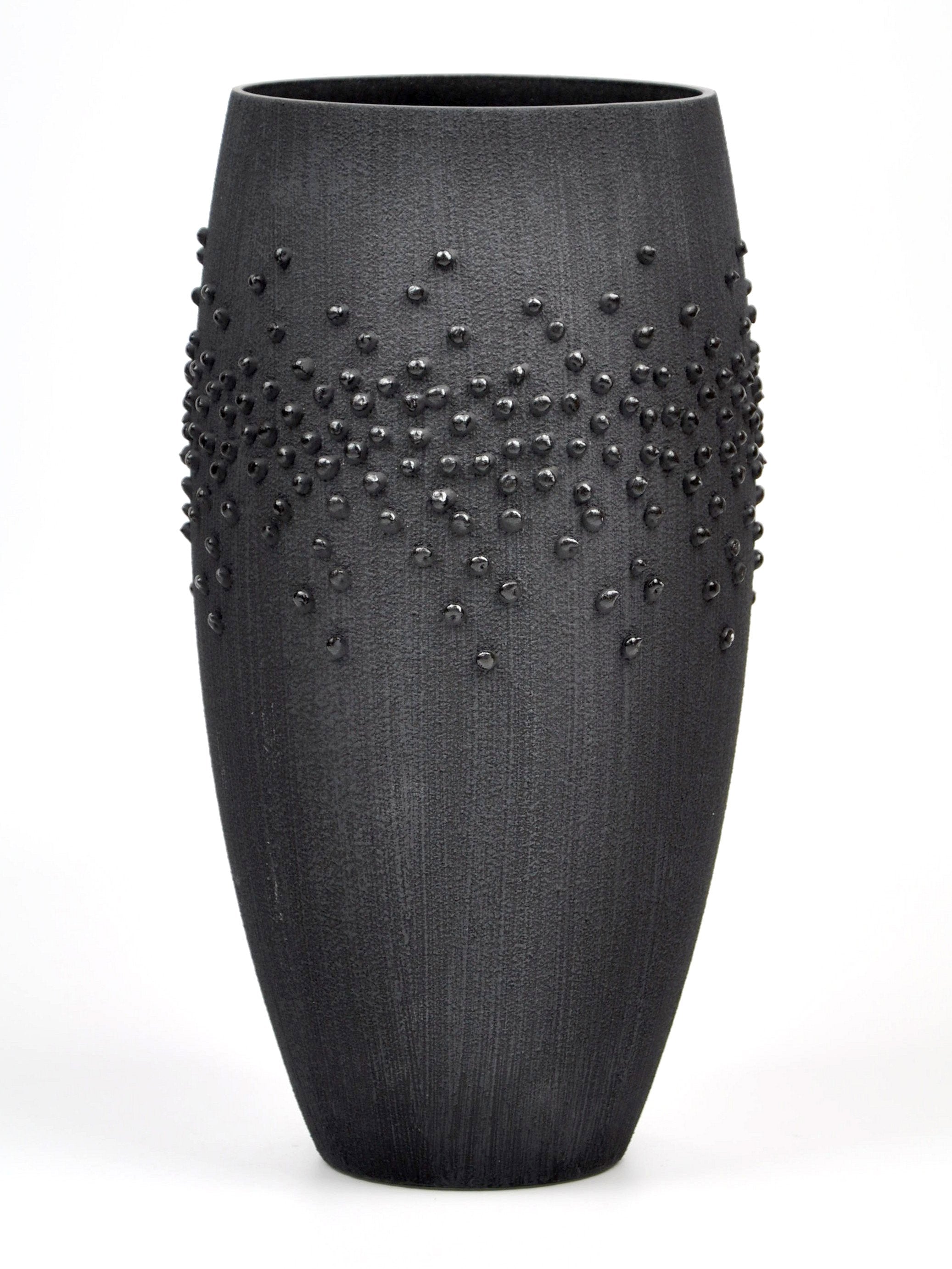 Handpainted black glass vase featuring unique artistic designs, perfect for home decor.