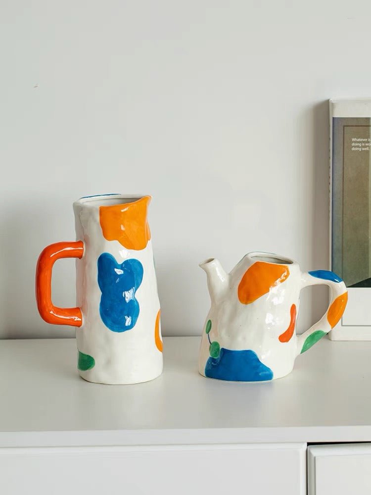 A colorful handpainted contemporary abstract ceramic vase featuring whimsical designs and vibrant colors, perfect for home decor.