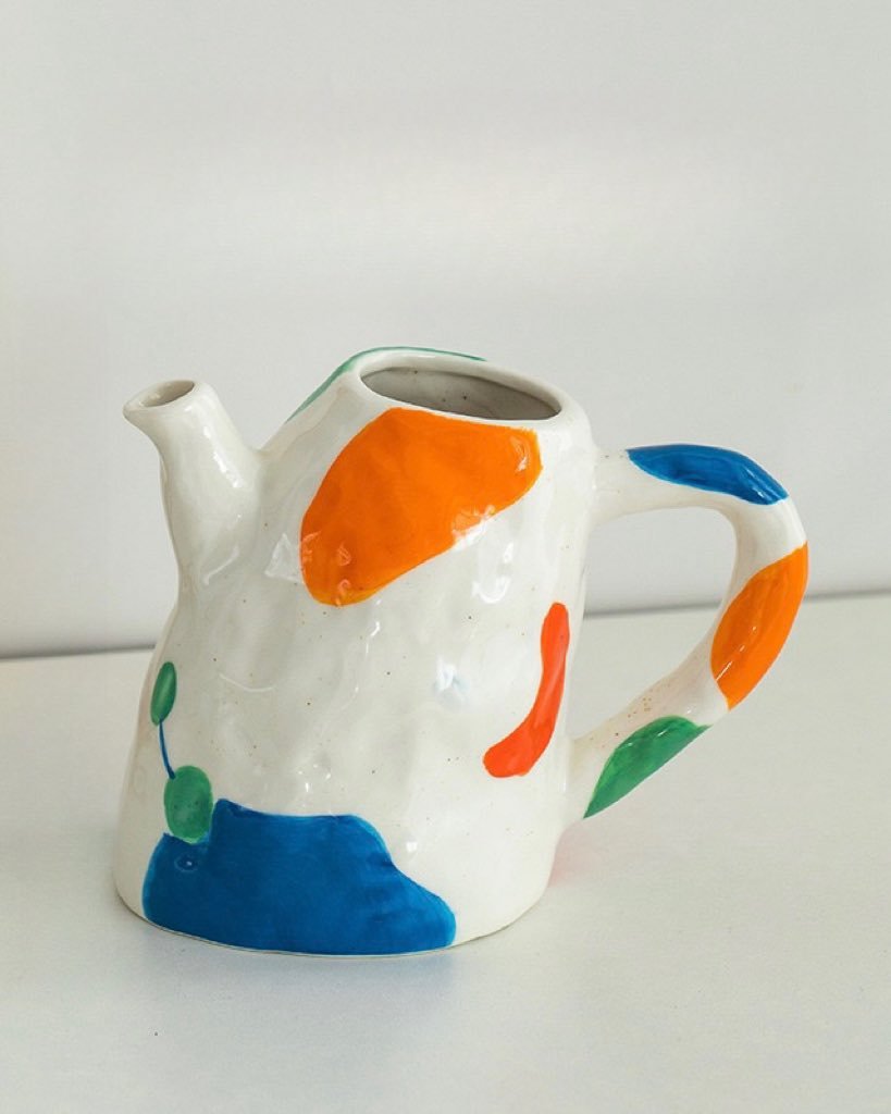 A colorful handpainted contemporary abstract ceramic vase featuring whimsical designs and vibrant colors, perfect for home decor.