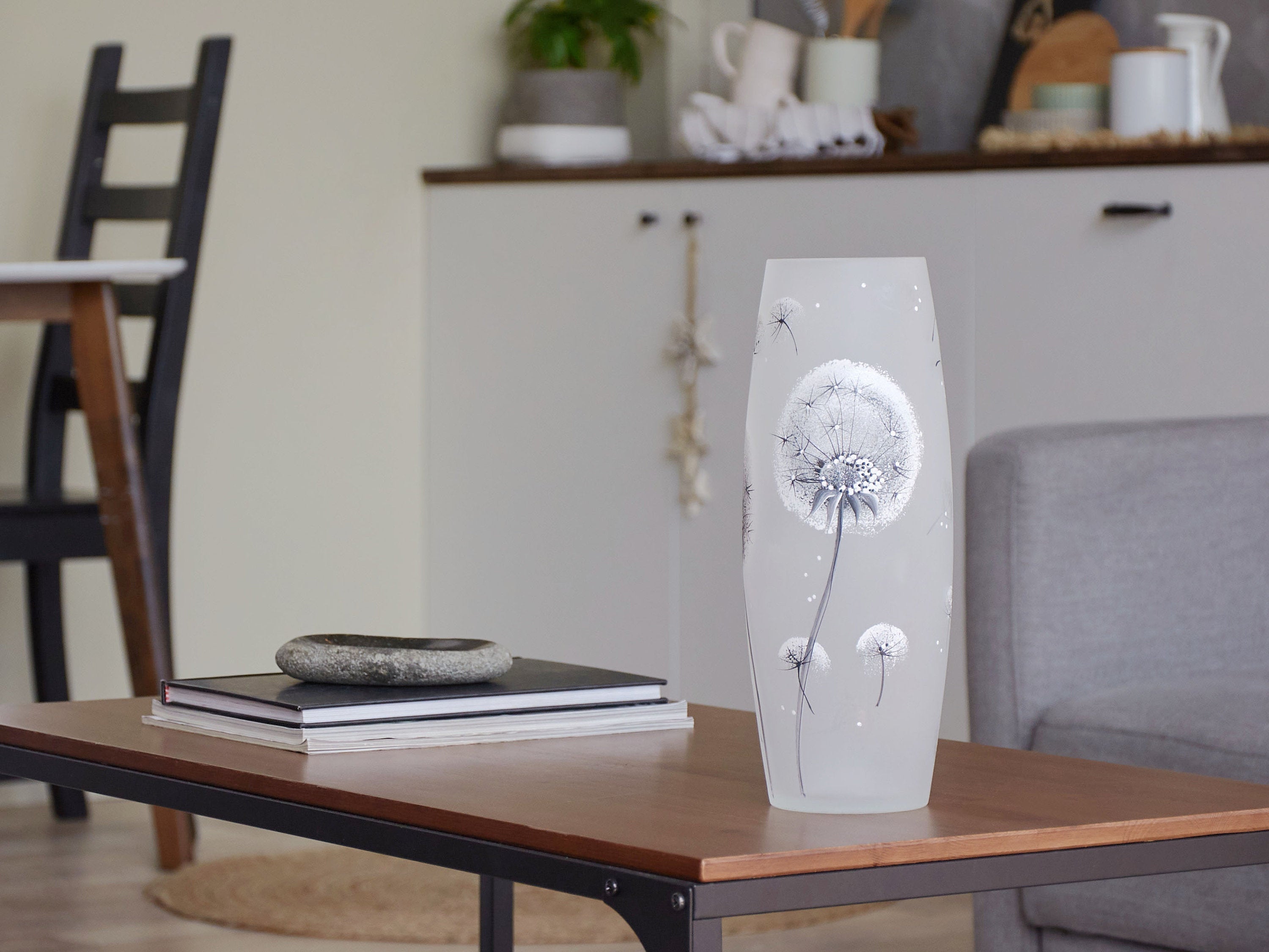 A beautifully hand-painted glass vase featuring intricate floral and geometric designs, showcasing vibrant colors and elegant shapes.