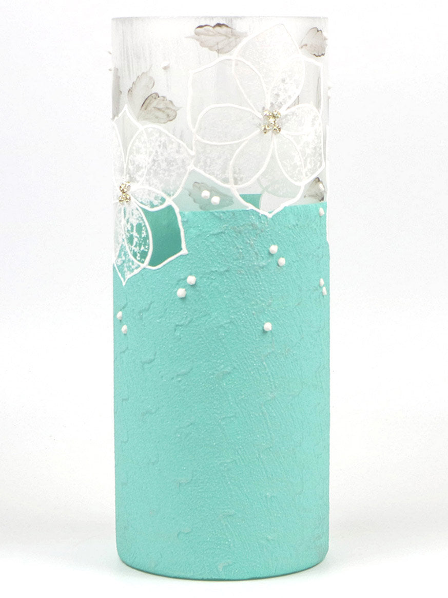 A beautifully hand-painted blue glass vase featuring unique floral and geometric designs, perfect for displaying flowers.