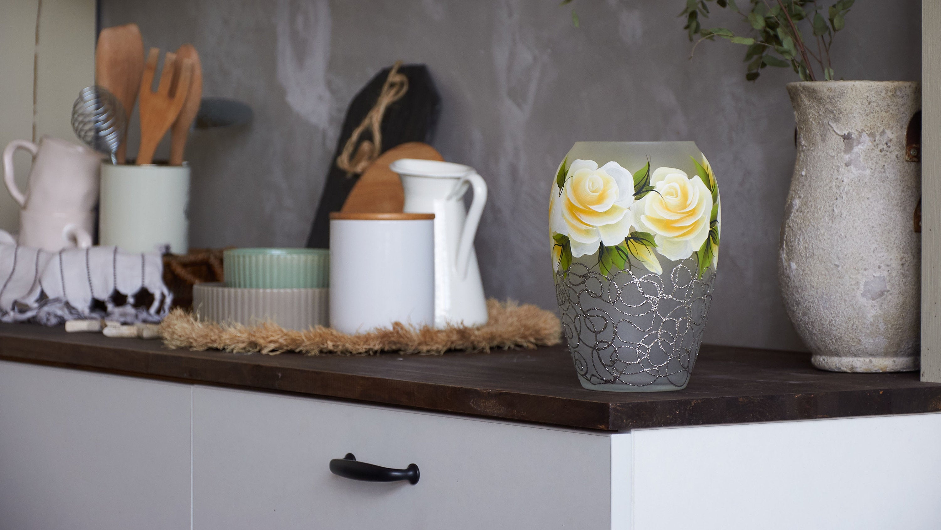 A beautifully hand-painted glass vase featuring unique floral and geometric designs, showcasing vibrant colors and artistic patterns.