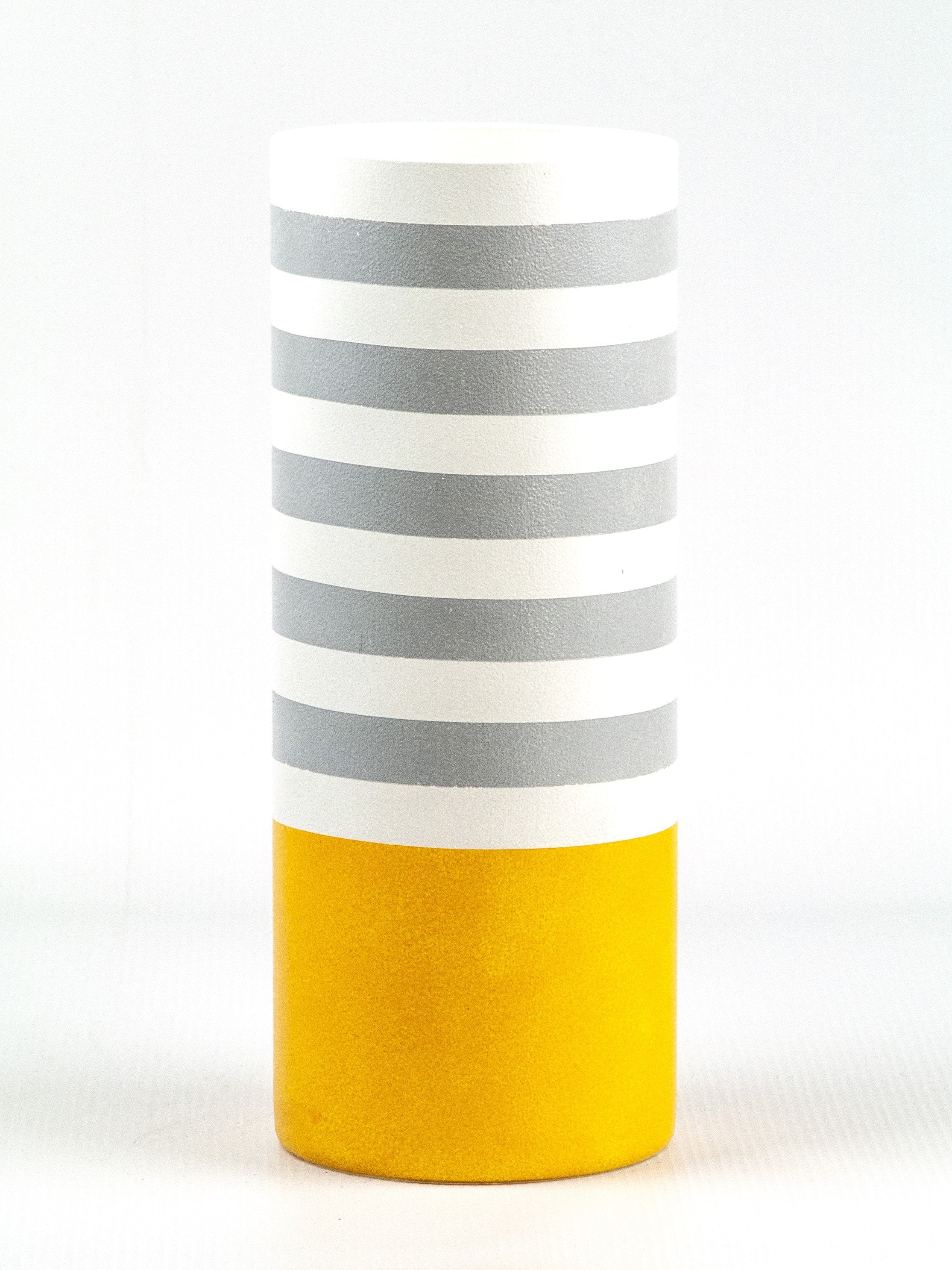 A beautifully hand-painted glass vase in vibrant yellow, showcasing unique floral designs, perfect for displaying flowers.