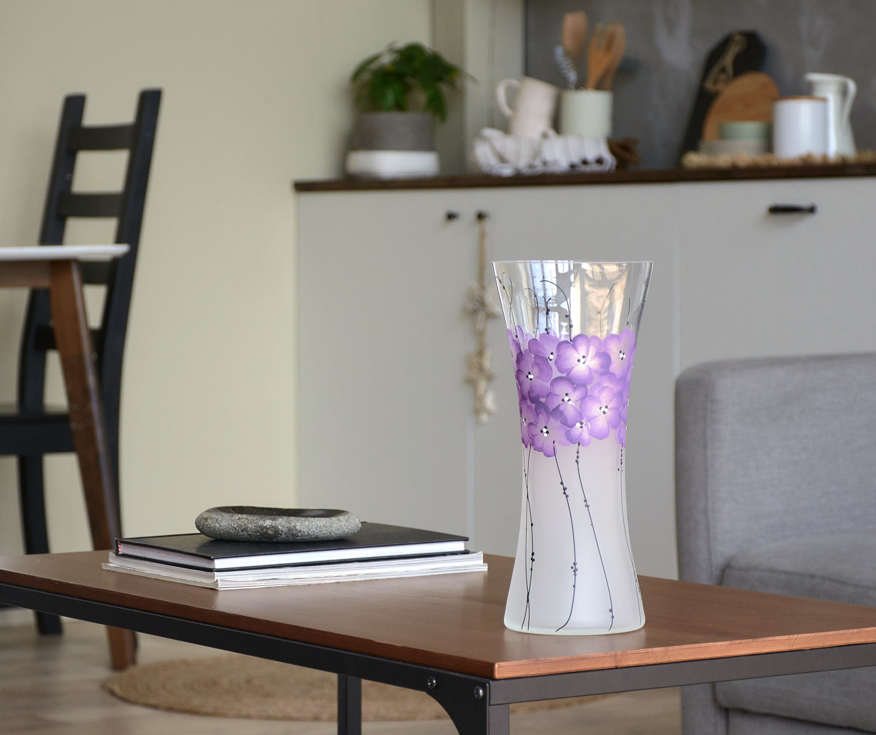 A beautifully hand-painted glass vase featuring intricate floral and geometric designs, showcasing vibrant colors and unique artistry.
