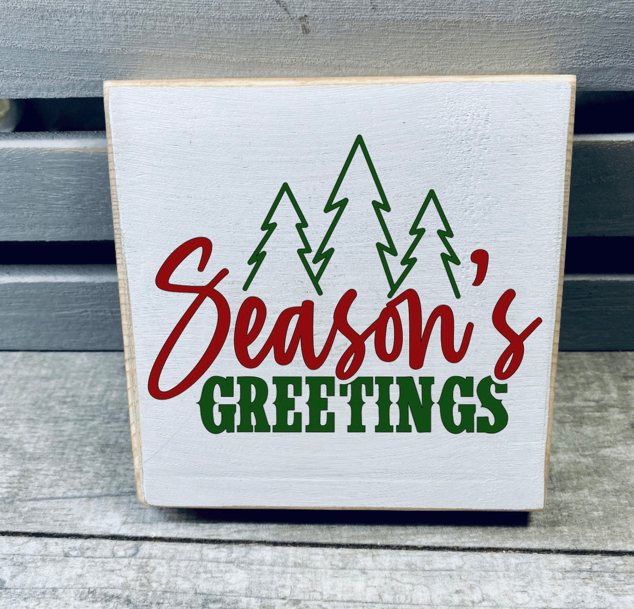 Hand-painted wooden Christmas sign featuring festive designs, perfect for tiered trays or shelves, made from solid pine with a sealed finish.