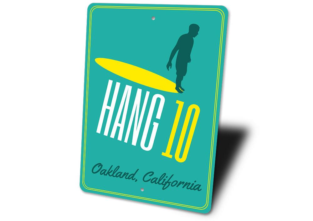 A vibrant Hang 10 sign made of high-quality aluminum, featuring beach-themed design elements, perfect for coastal decor.