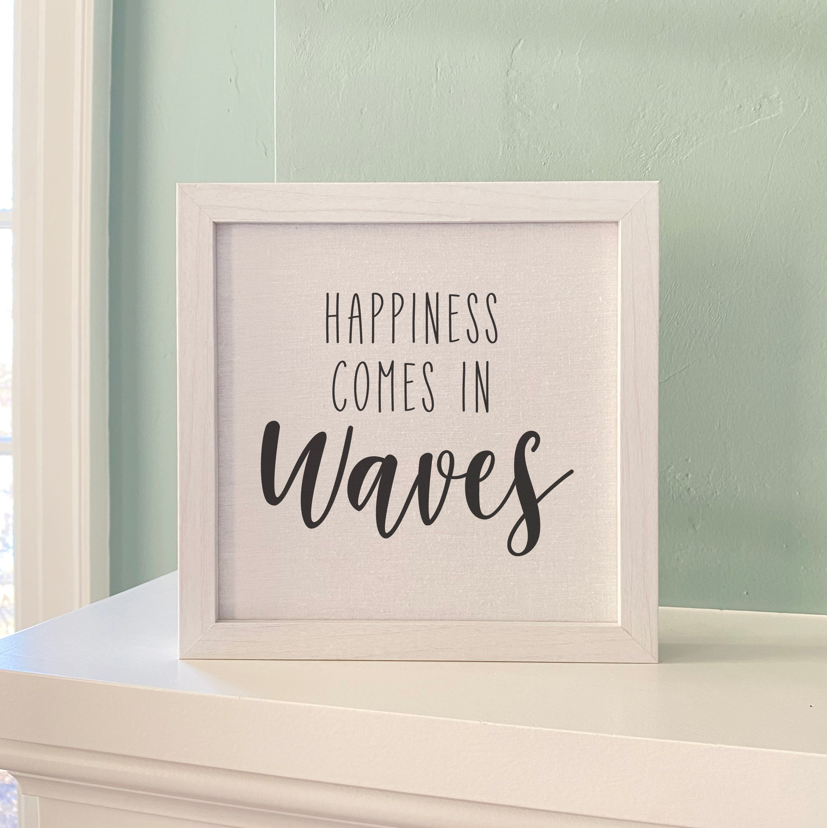Happiness Comes in Waves framed sign with a stylized wood frame, featuring a linen-look background and eco-friendly printing.