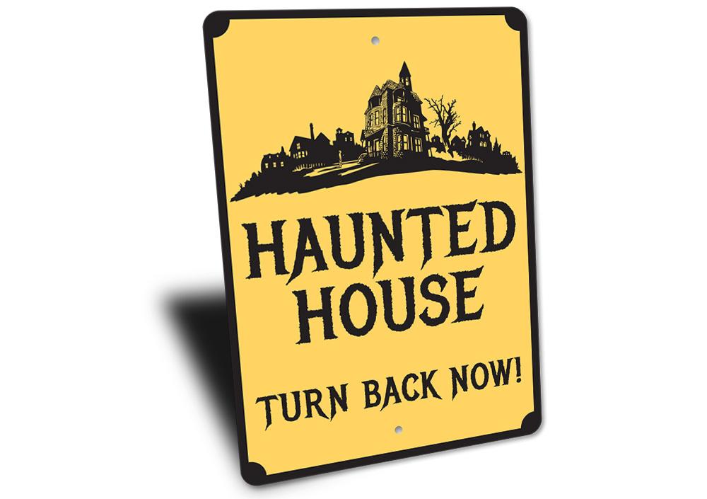 A spooky Haunted House Sign made of durable aluminum, featuring eerie graphics perfect for Halloween decorations.