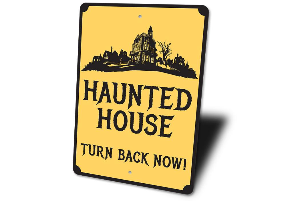 A spooky Haunted House Sign made of durable aluminum, featuring eerie graphics perfect for Halloween decorations.