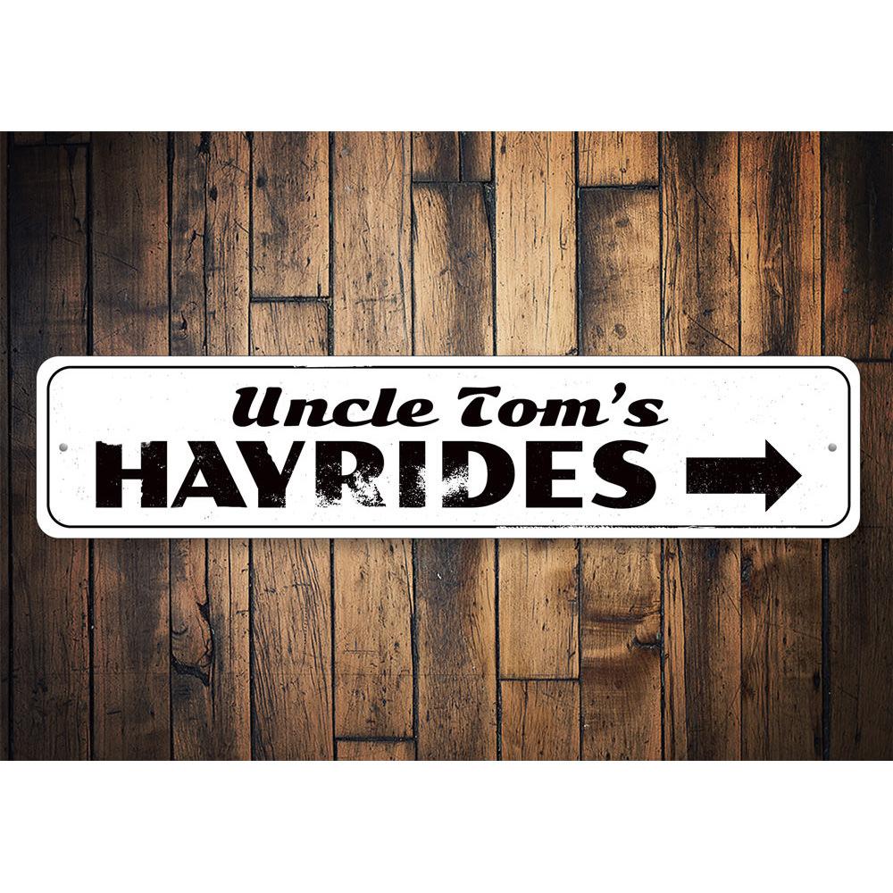 A decorative Hayrides Sign made of high-quality aluminum, featuring spooky Halloween-themed graphics, perfect for seasonal decor.