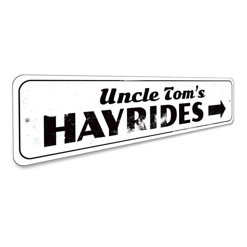 A decorative Hayrides Sign made of high-quality aluminum, featuring spooky Halloween-themed graphics, perfect for seasonal decor.