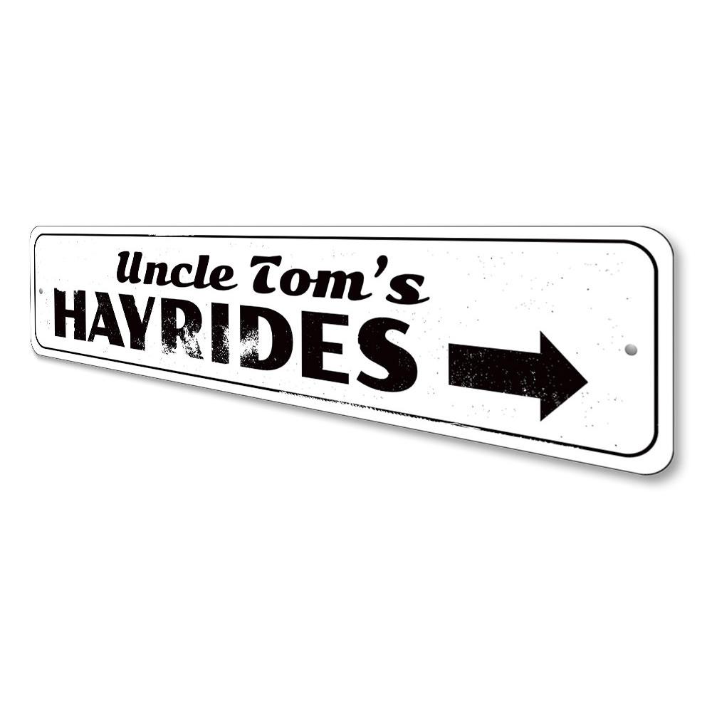 A decorative Hayrides Sign made of high-quality aluminum, featuring spooky Halloween-themed graphics, perfect for seasonal decor.
