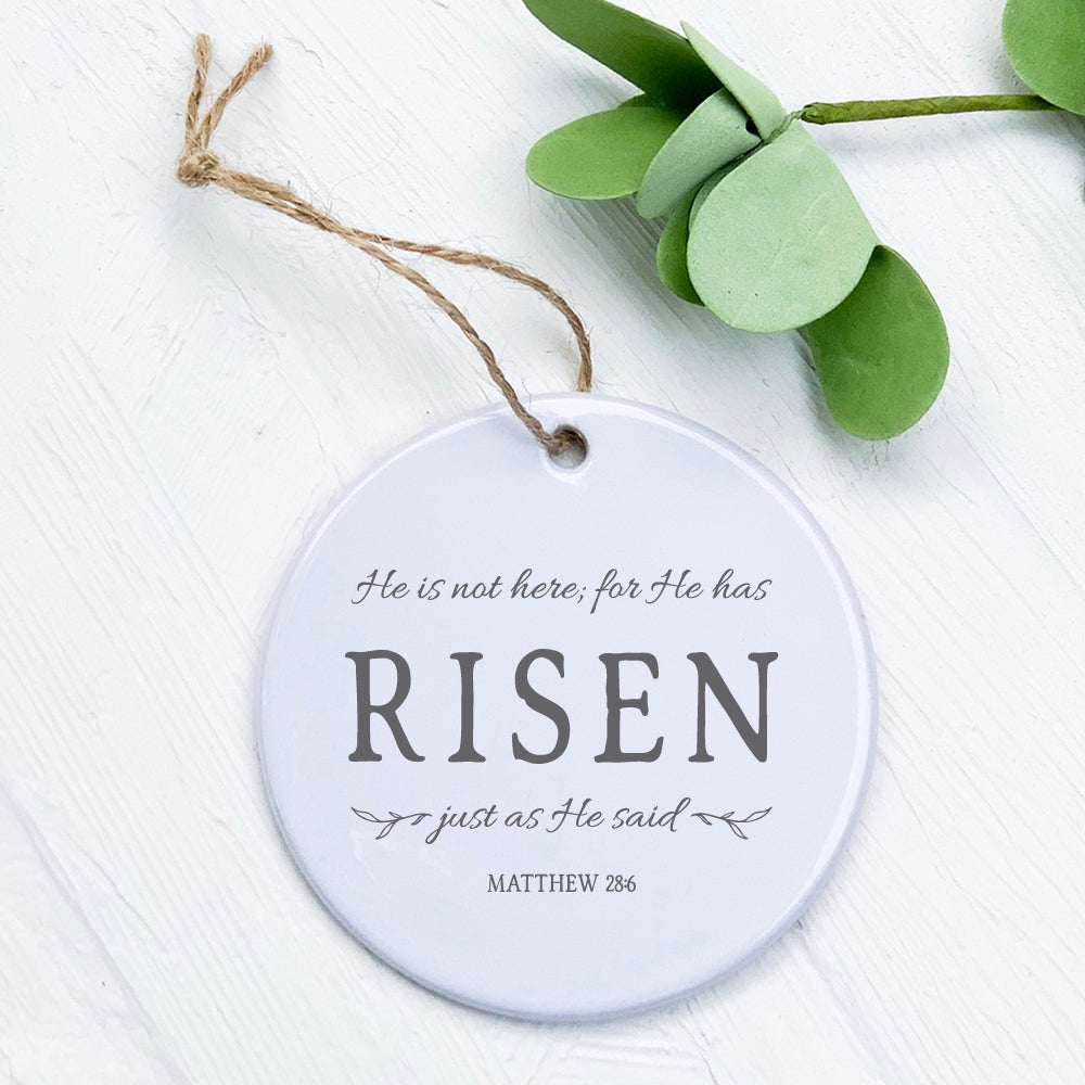 He Has Risen porcelain ornament featuring original design, 2.75 inches in diameter with a smooth glossy finish.