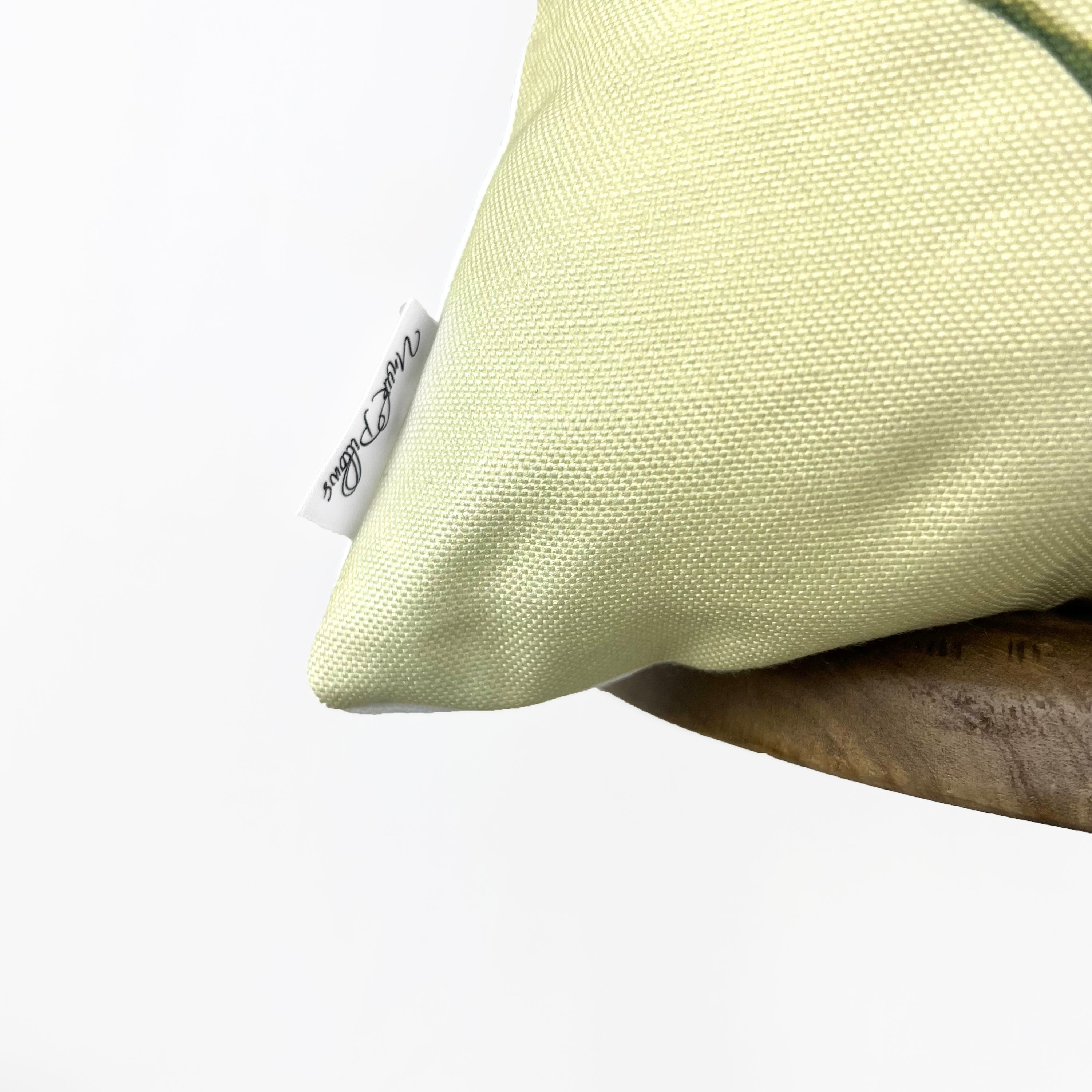 He Is Risen accent pillow with white background and colorful Spring design, perfect for Easter decor.