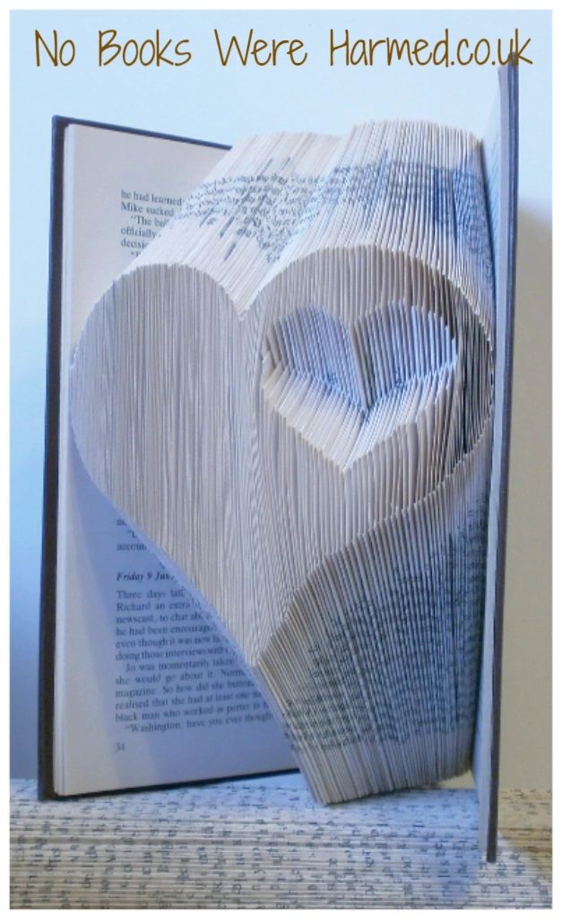 Handcrafted Heart within a Heart art piece made from vintage book pages, showcasing intricate folds and unique design.