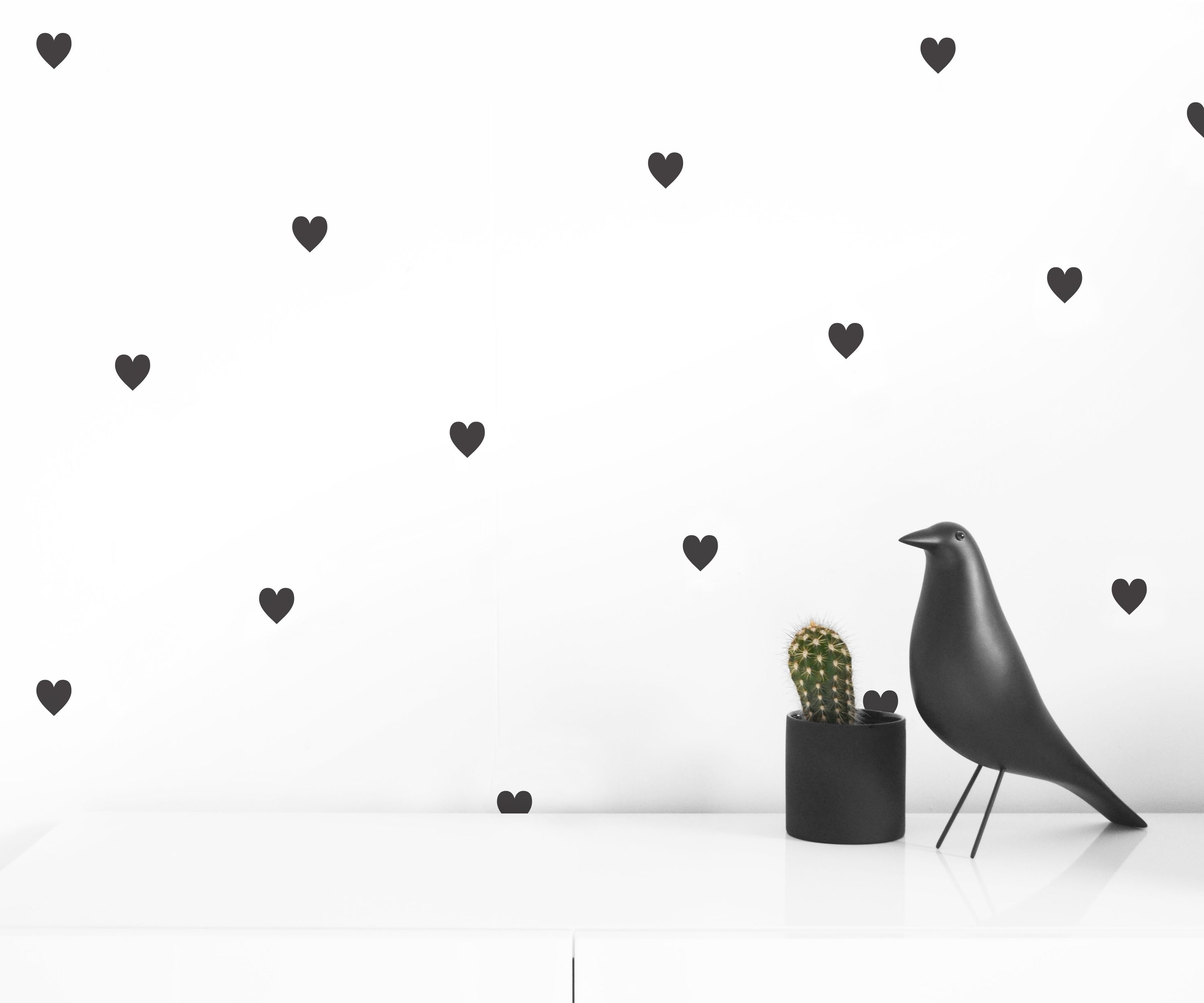 A pack of 50 black hearts wall decals, perfect for home decoration.