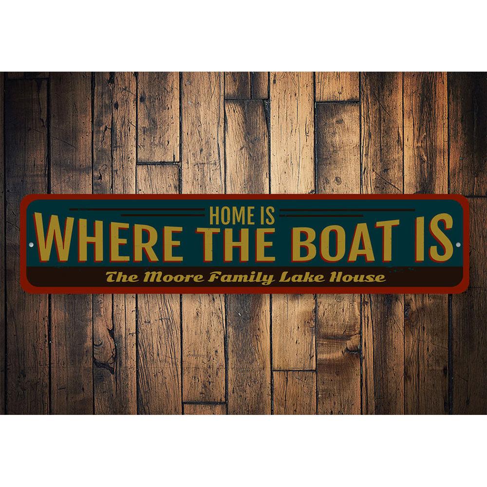 A decorative metal sign reading 'Home is Where the Boat is', showcasing a lakeside theme, perfect for cabin decor.