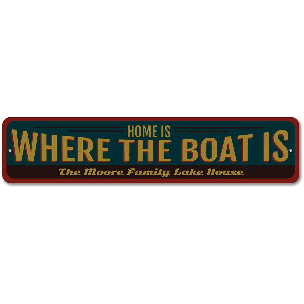 A decorative metal sign reading 'Home is Where the Boat is', showcasing a lakeside theme, perfect for cabin decor.