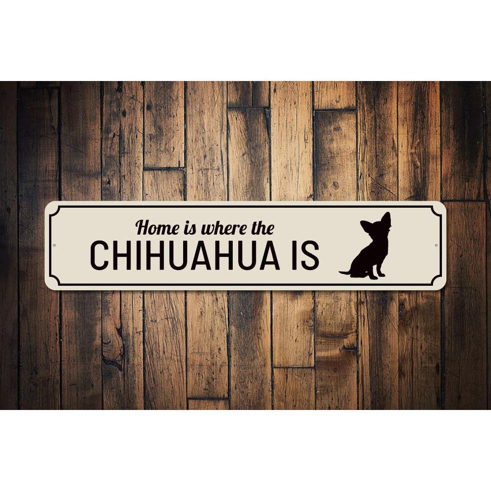 A decorative aluminum sign that reads 'Home is Where the Dog is', featuring a charming design perfect for dog lovers.