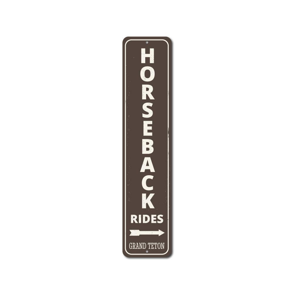 A decorative Horseback Rides Vertical Sign made of high-quality aluminum, showcasing a rustic design perfect for lakeside decor.