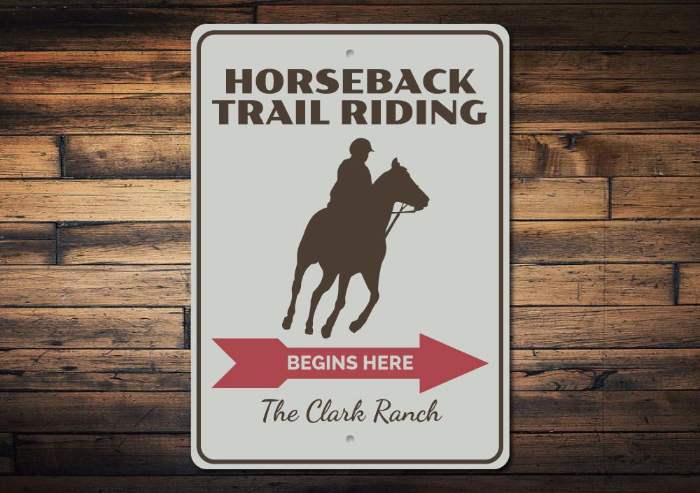 A decorative Horseback Trail Rider Sign made of high-quality aluminum, featuring a rustic design perfect for home decor.
