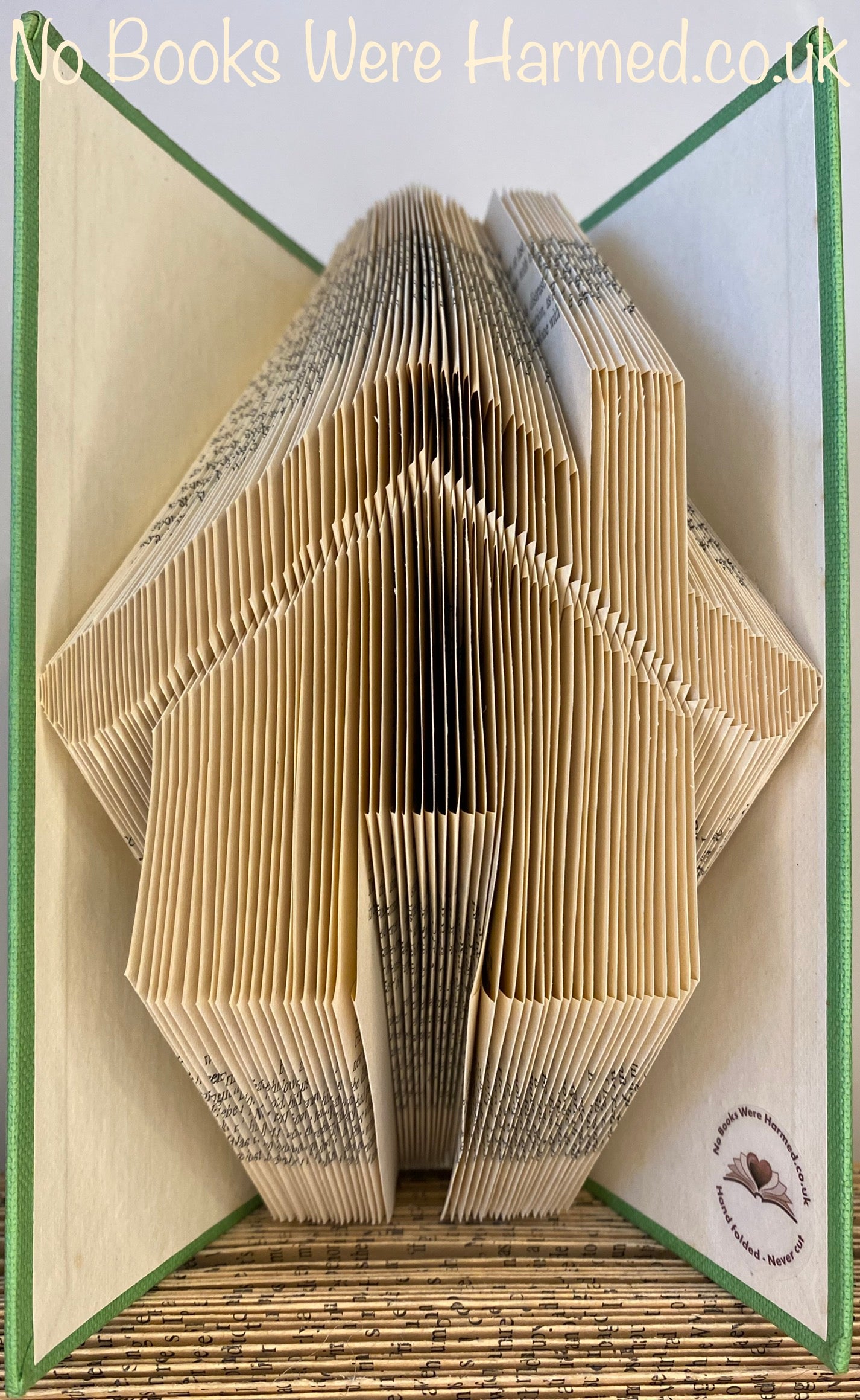 Handcrafted book art made from vintage books, showcasing unique designs and colors.