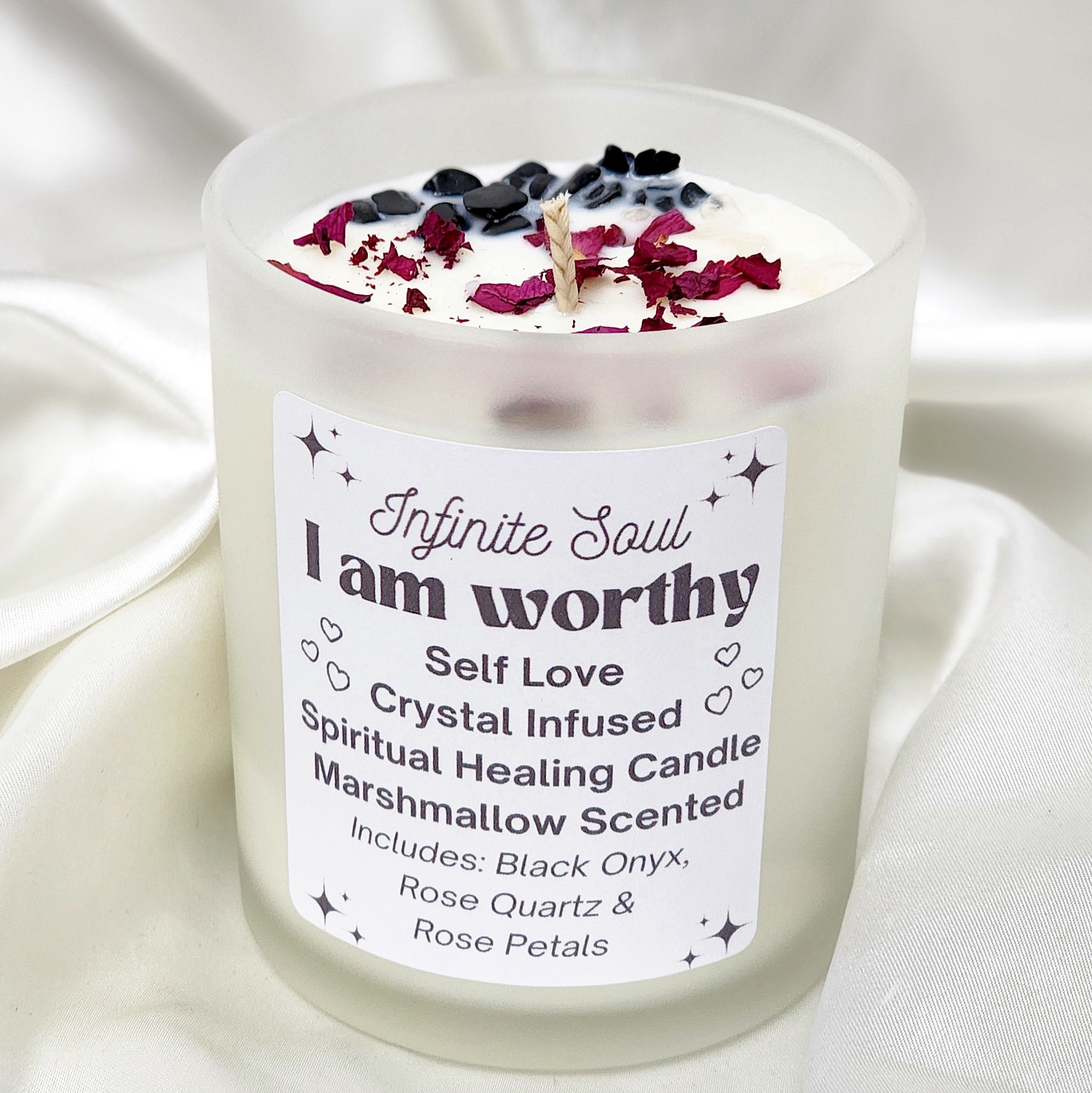 I am Worthy Self Love Crystal Infused Candle in a clear jar, featuring rose petals and crystals, with a marshmallow scent.