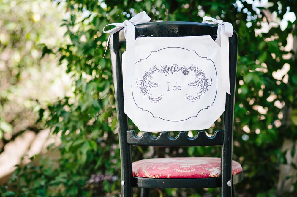 Elegant 'I Do' chair banner designed for weddings, featuring stylish lettering on high-quality fabric.