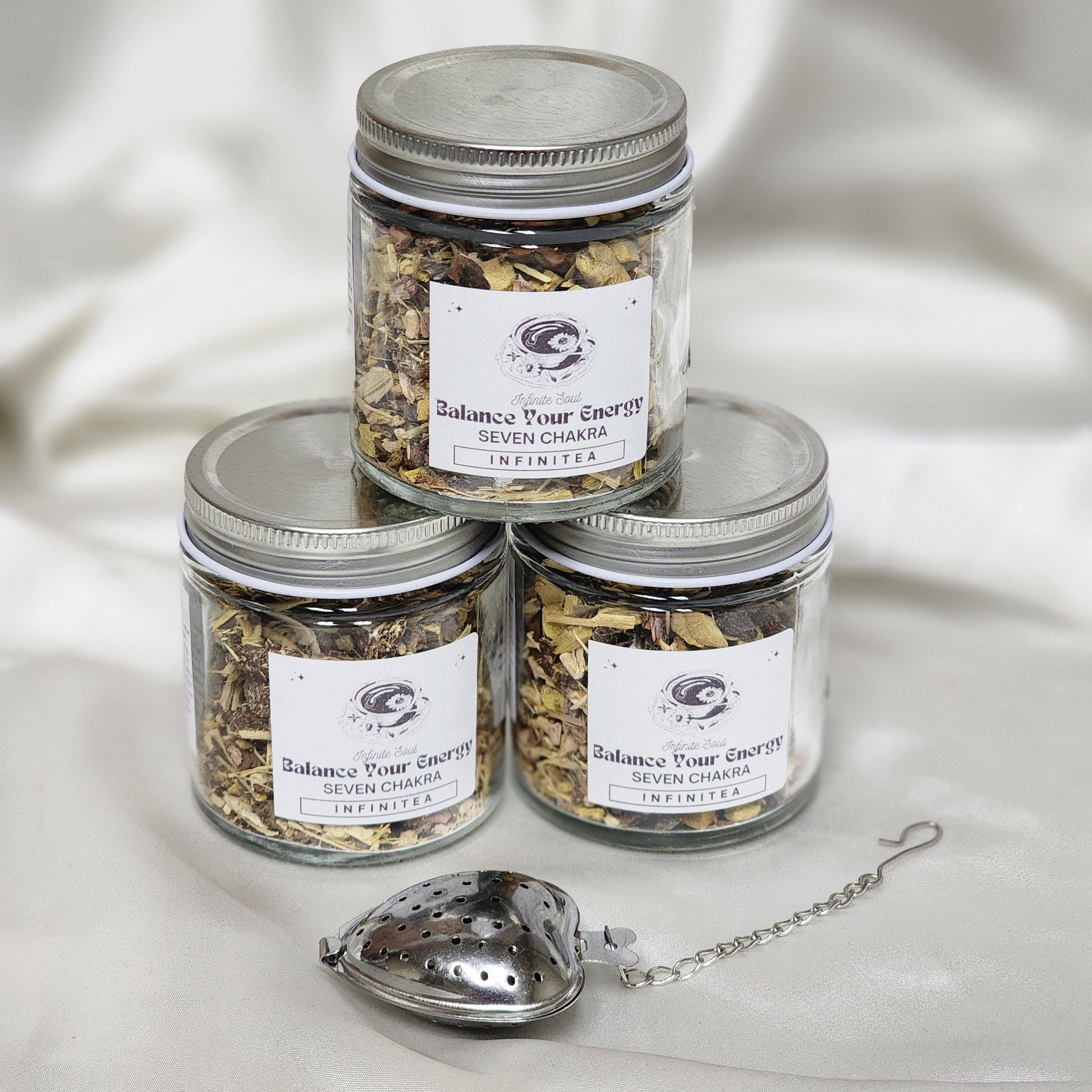 A vibrant package of Infinitea Balance Your Energy Seven Chakra Organic Herbal Tea Blend featuring natural herbs and a calming design.