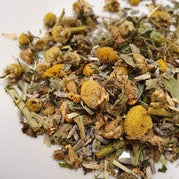 A soothing cup of Infinitea Sweet Dreams herbal tea blend with chamomile, lavender, and lemon balm, promoting relaxation and better sleep.