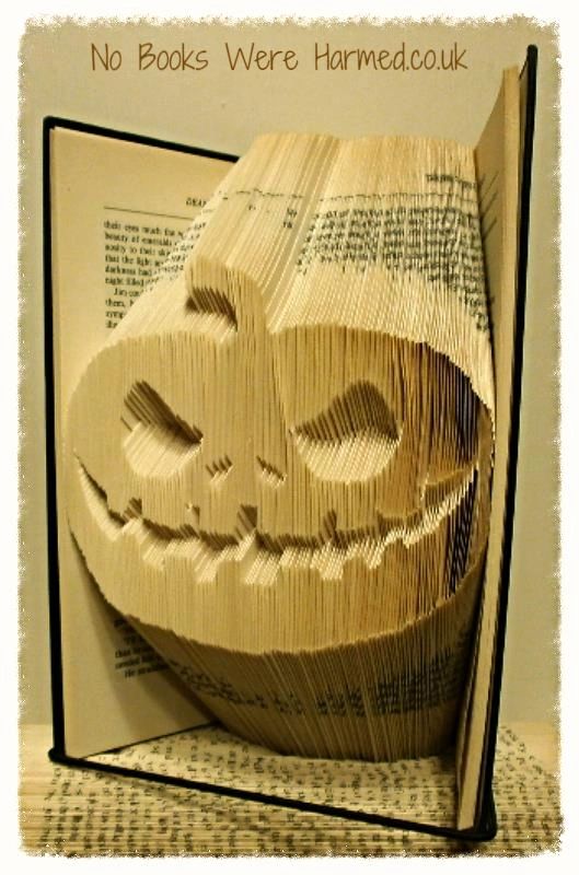 Handcrafted Jack The Lantern Pumpkin Pal made from vintage book pages, showcasing intricate folds and unique design.