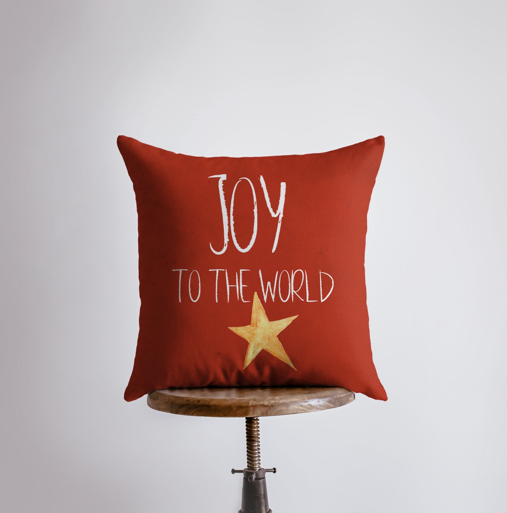 Handmade red throw pillow with 'Joy to the World' text and gold star, perfect for Christmas home decor.