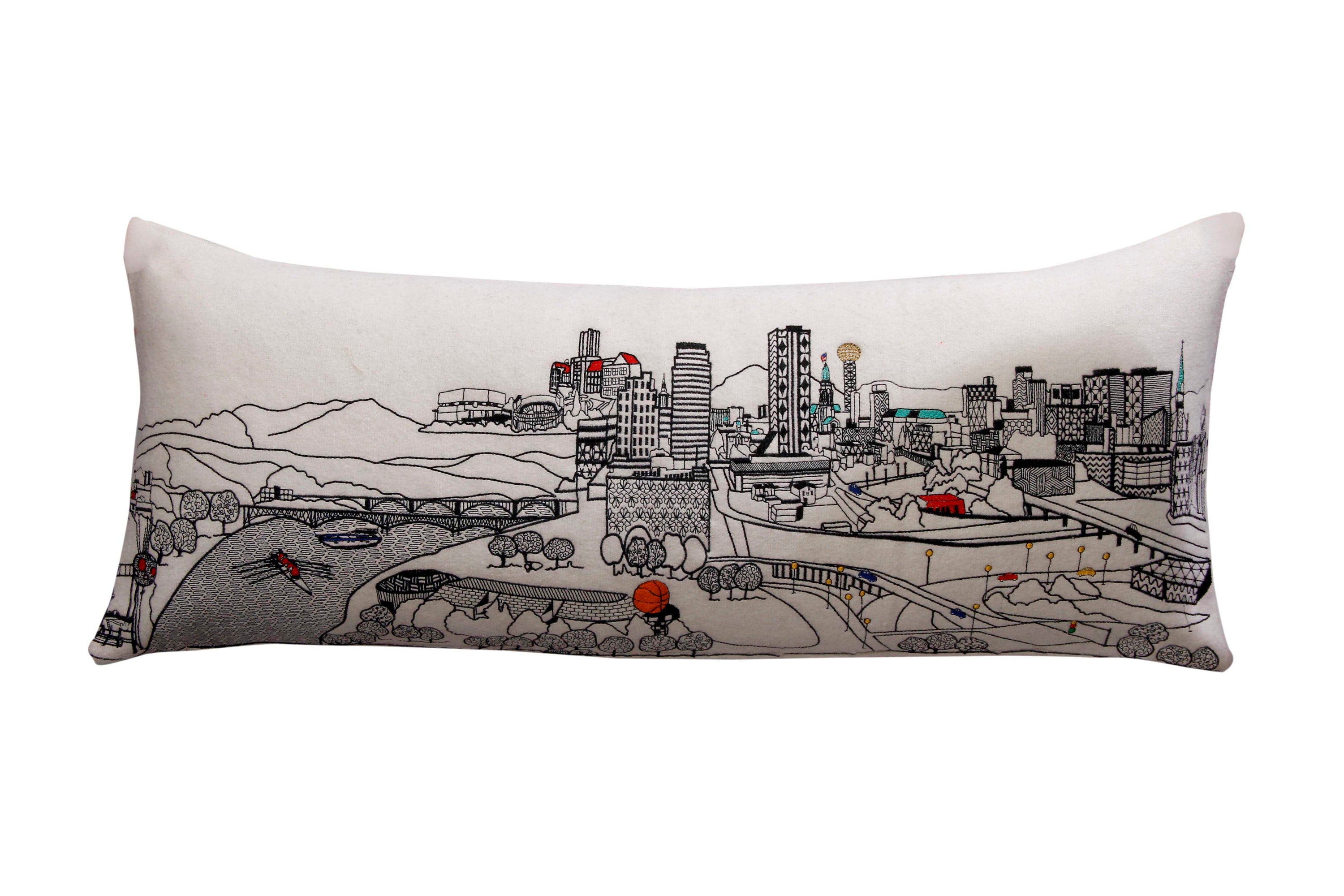 Knoxville Pillow featuring a vibrant design inspired by Knoxville, Tennessee, with a red zipper at the bottom.