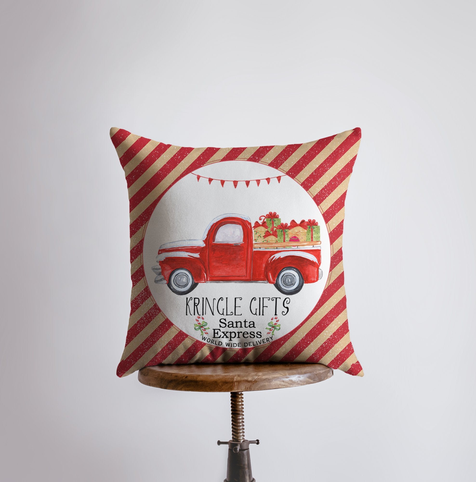 Kringle Gifts Red Christmas Truck Pillow Cover featuring a vintage red truck with gifts, striped corners, and candy cane red stripe back.