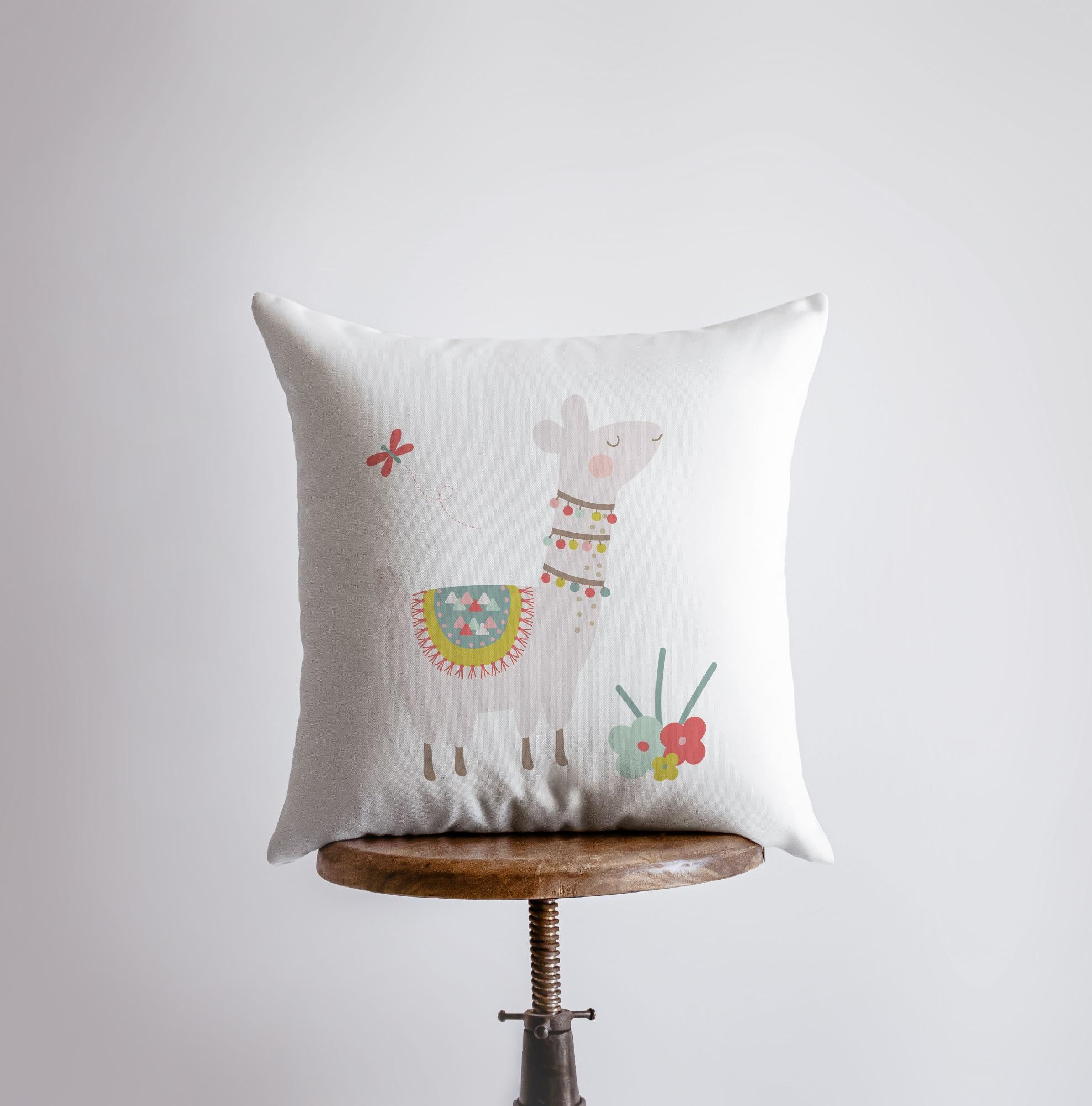 A charming Llama pillow cover featuring vibrant flowers on the front and a white back, showcasing a concealed zipper for easy use.