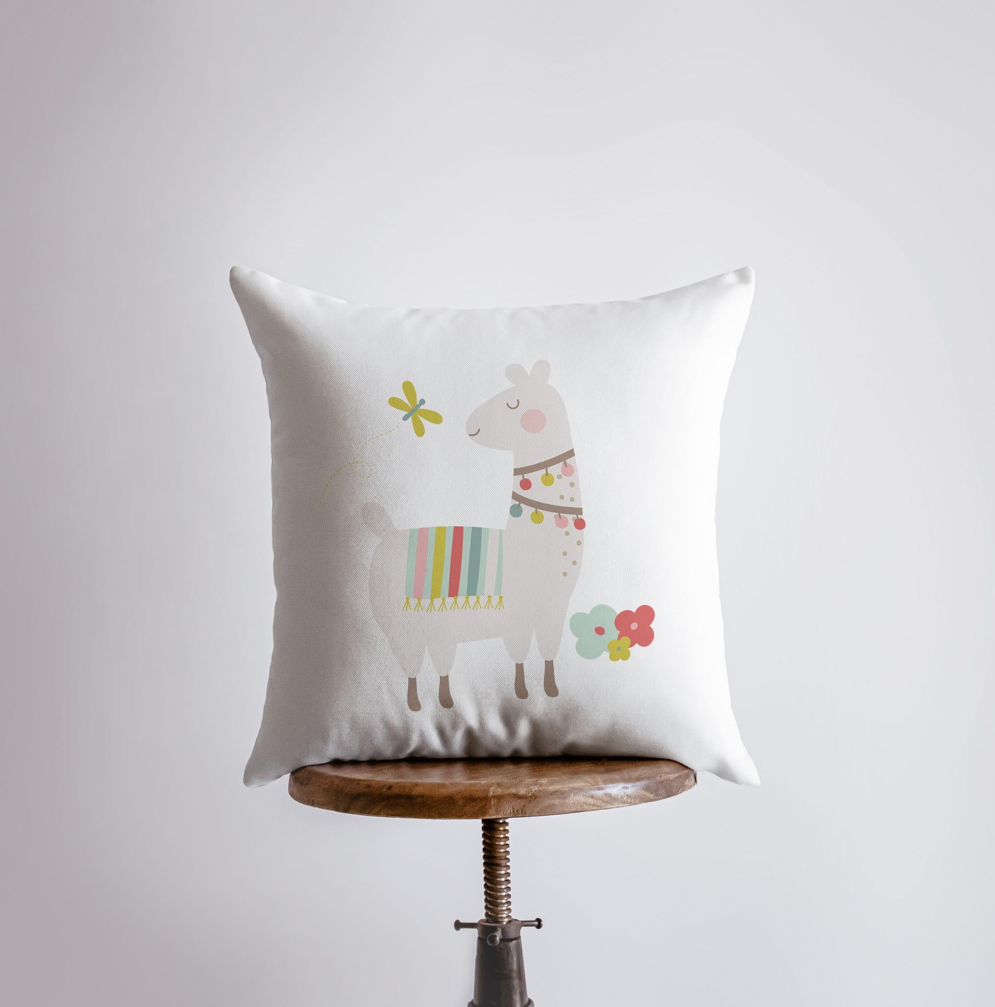 A charming throw pillow featuring a cute llama design with flowers and a necklace, showcasing vibrant colors on a soft fabric.