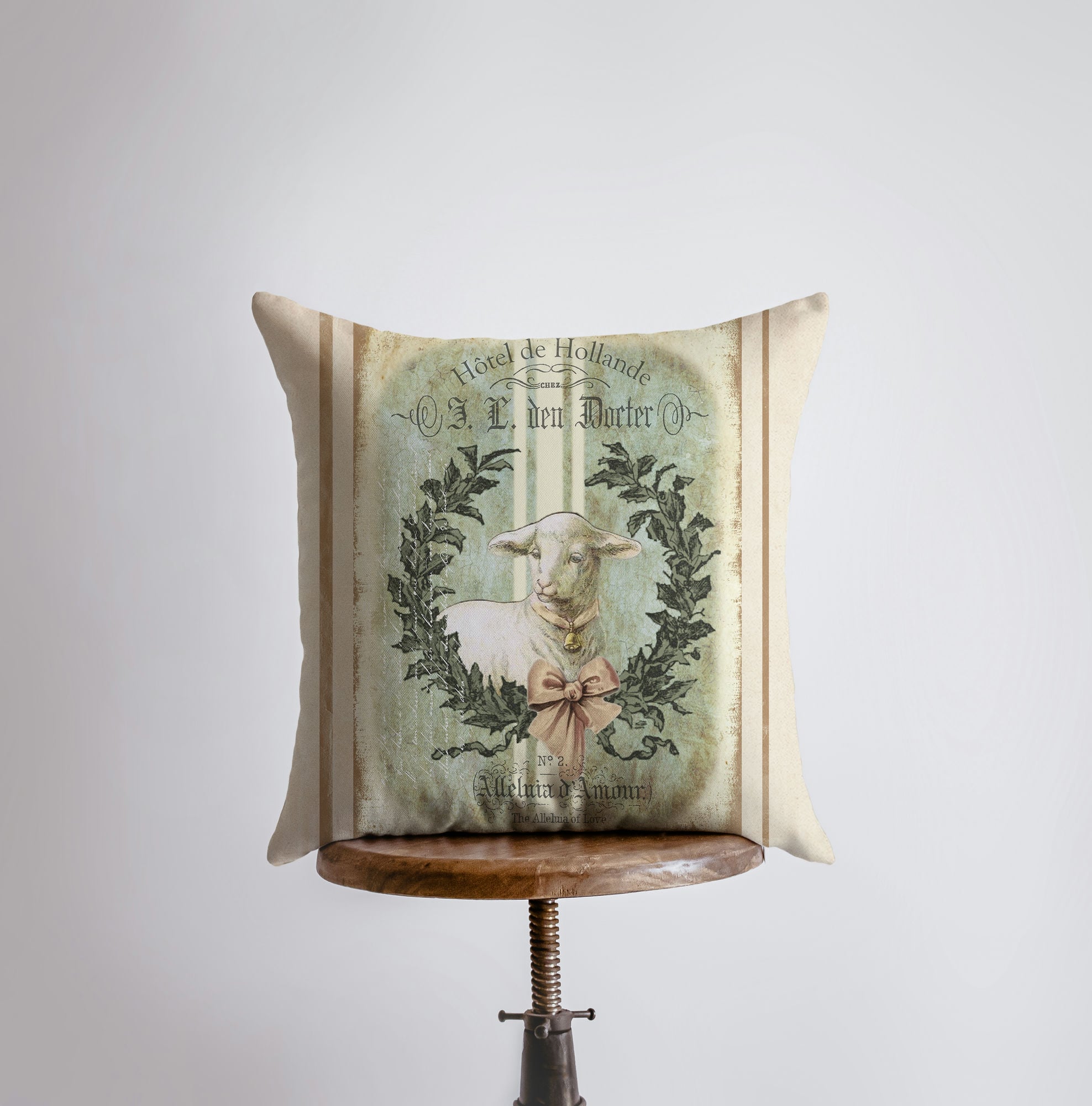 A vintage lamb pillow cover featuring a cute lamb with a pink bell, perfect for farmhouse and country decor.