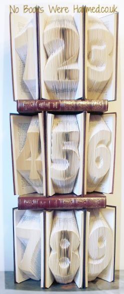 Large, bold, chunky numbers made from vintage book pages, perfect for wedding table settings, showcasing unique hand-folded artistry.