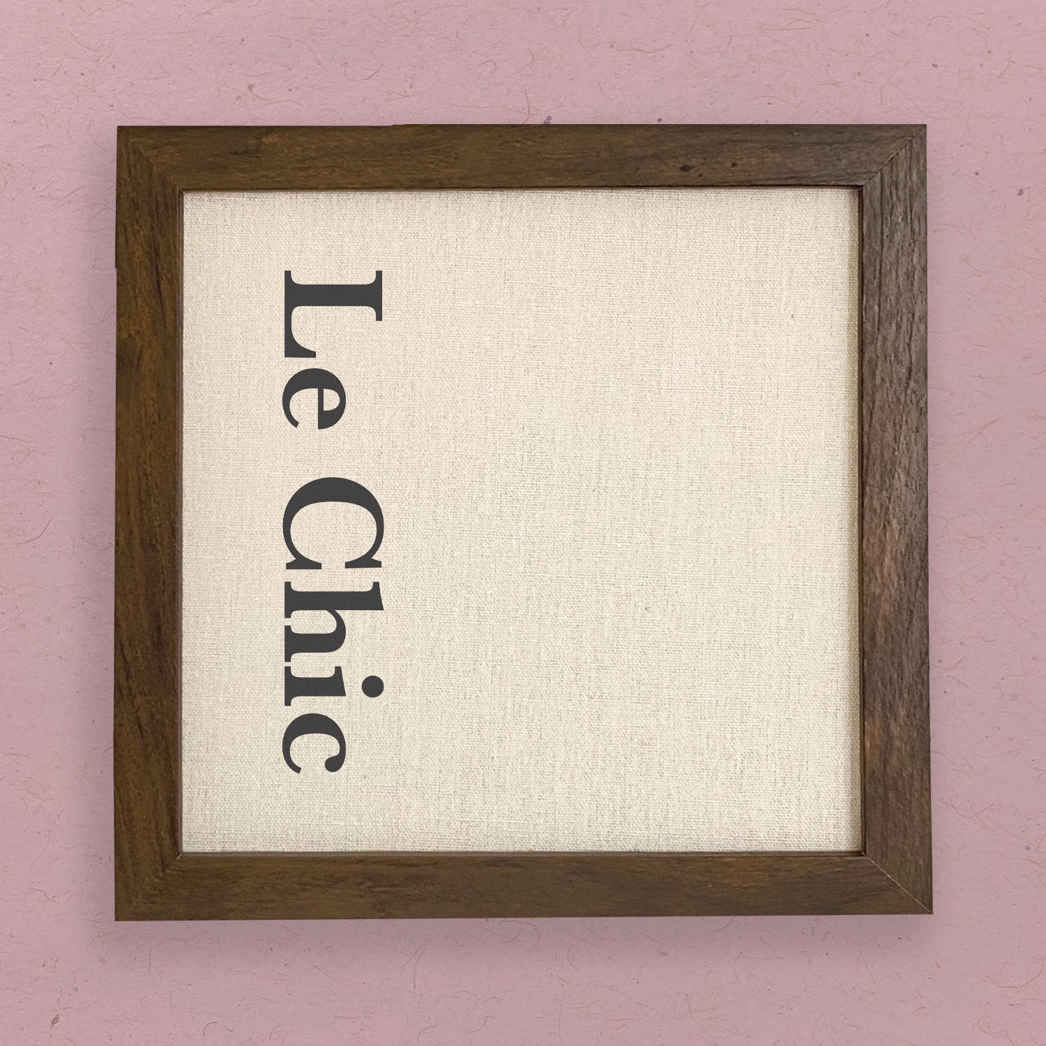 Le Chic Framed Sign featuring a stylish wood frame in walnut or white-washed finish, with eco-friendly ink printing on a linen-look background.