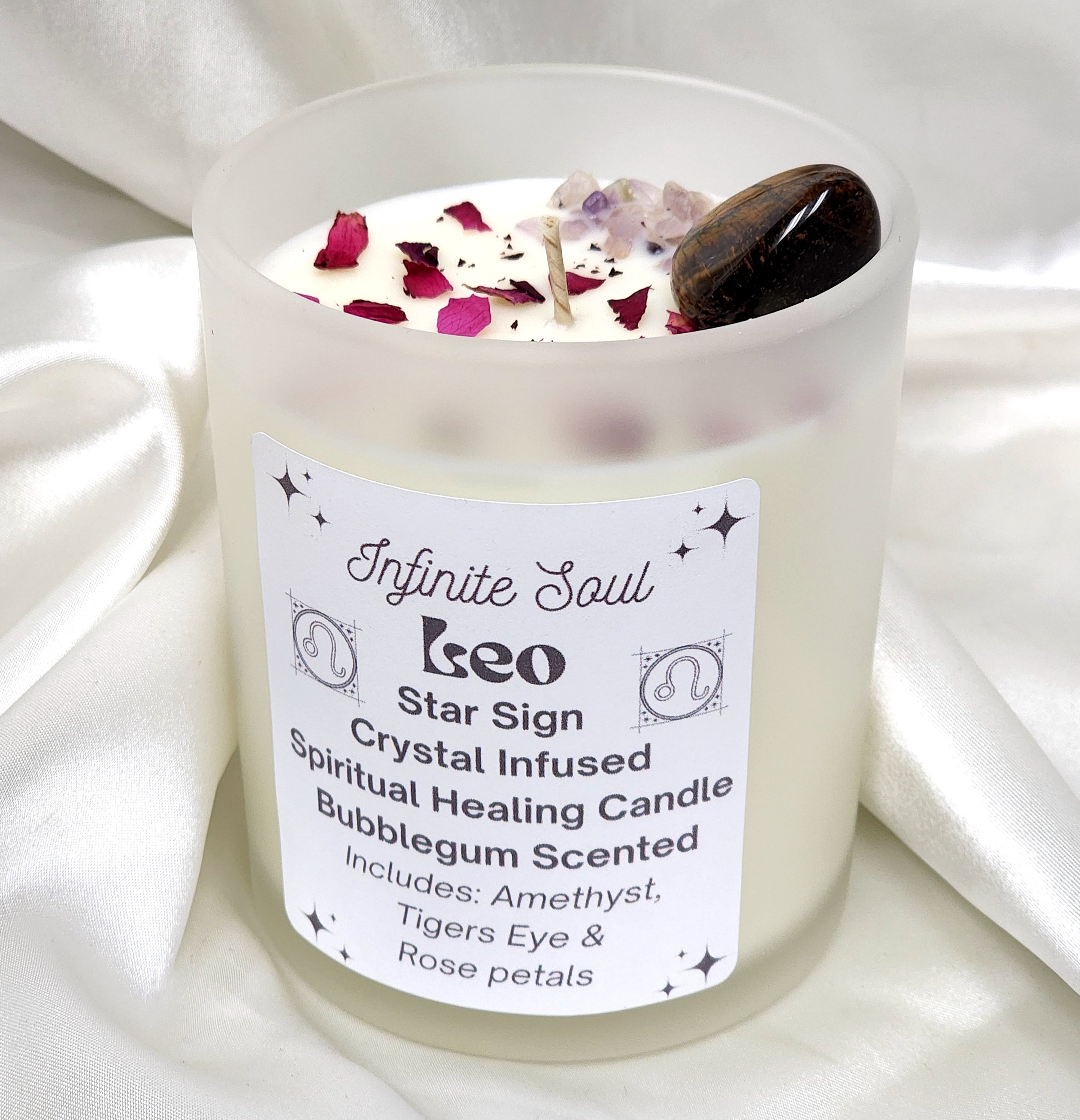 Leo Star Sign Crystal Infused Candle with bubblegum scent, featuring Amethyst and Tigers Eye crystals, and dried rose petals.