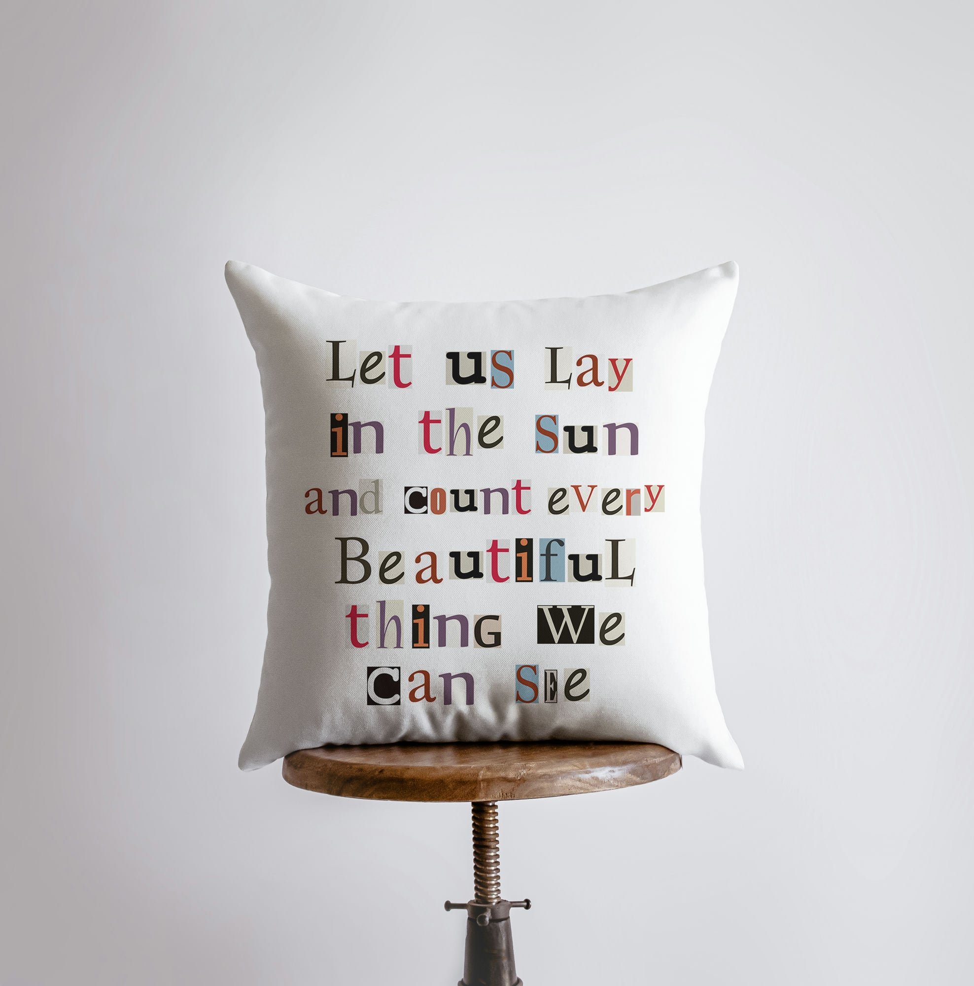 Handmade 'Let us Lay in the Sun' pillow cover featuring a poetic design on a white background, available in various sizes.