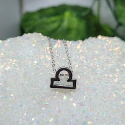 A beautifully crafted Libra Necklace featuring the zodiac scales symbol, representing balance and harmony.