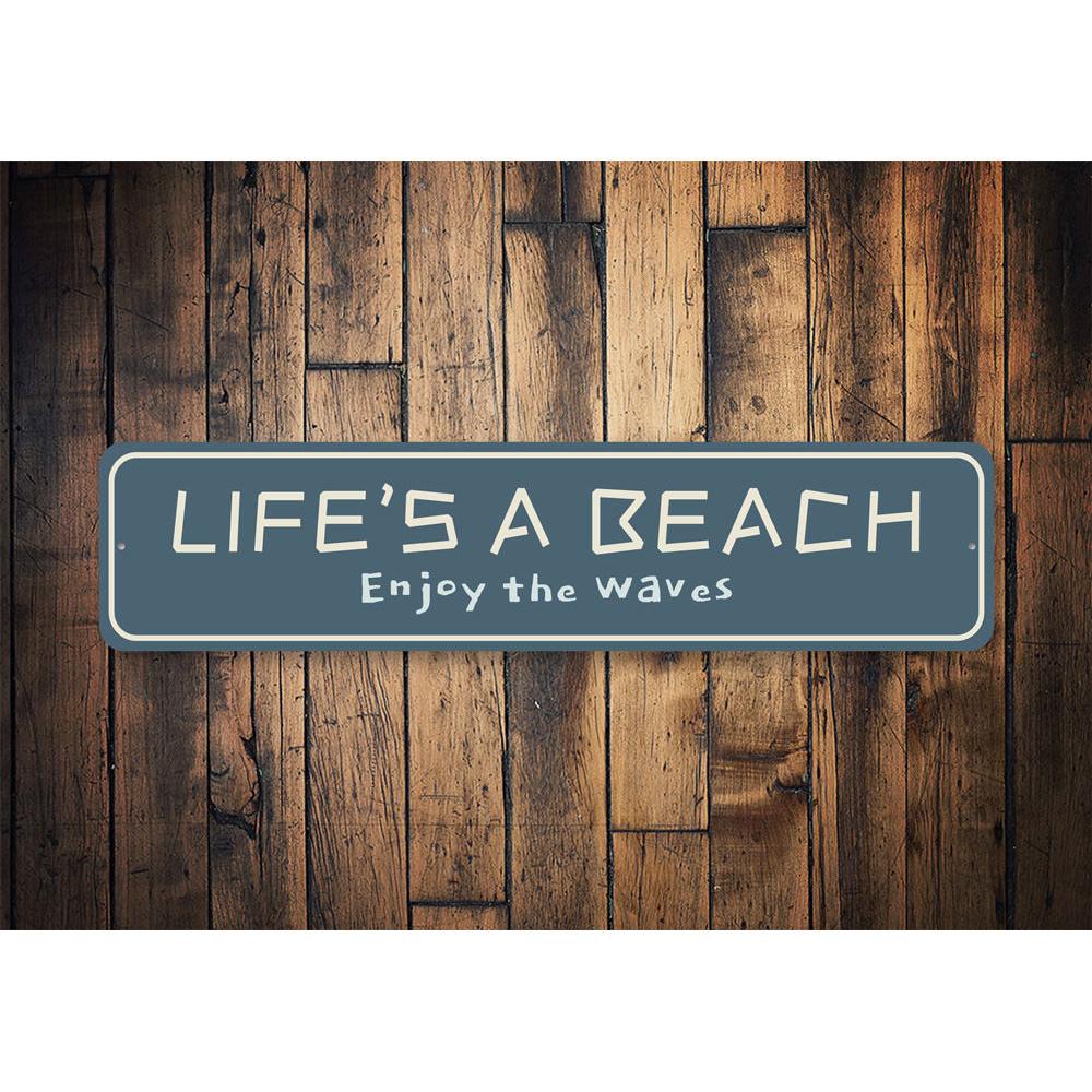 A vibrant metal sign reading 'Life is a Beach Enjoy the Waves', showcasing beach-themed decor with a sunny coastal vibe.