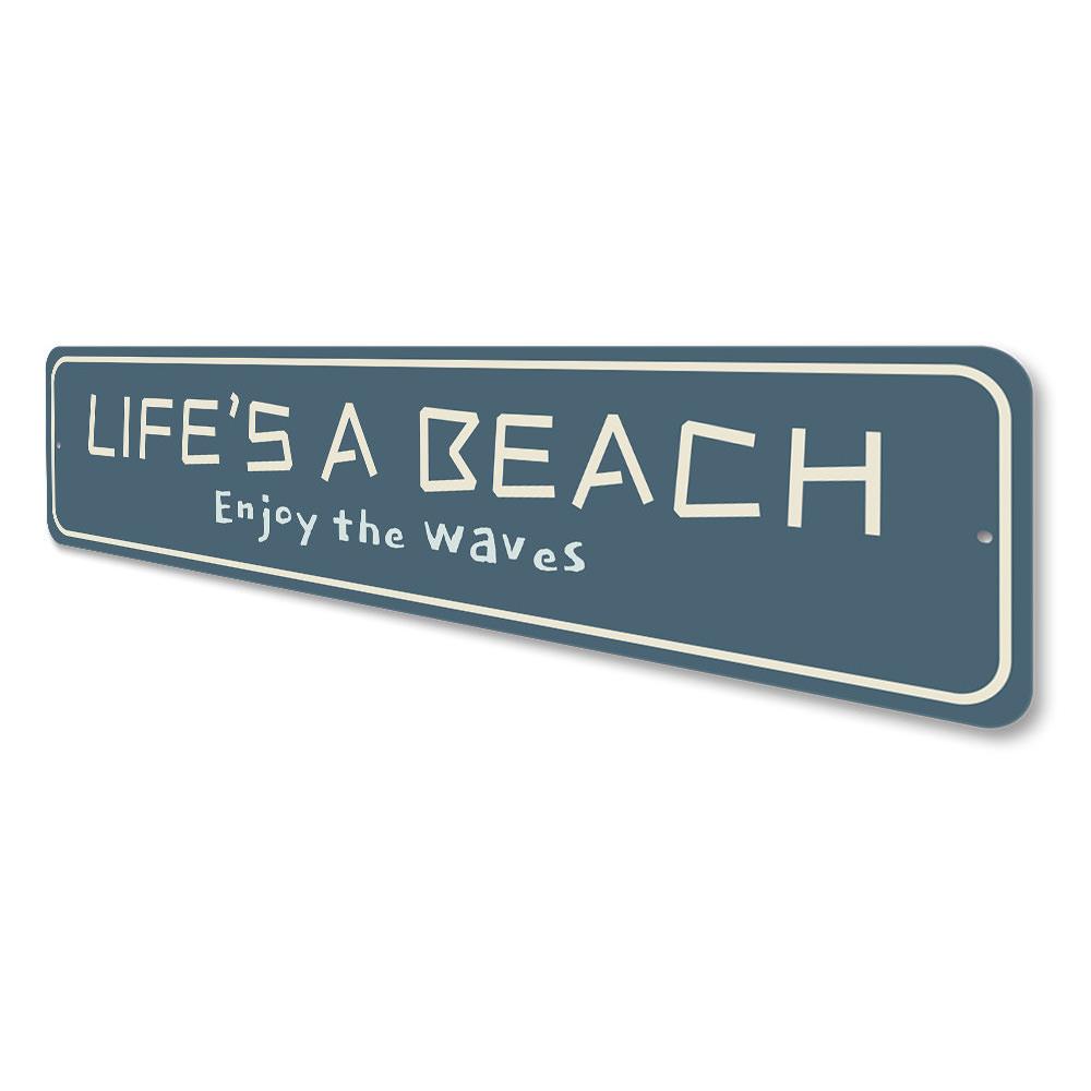A vibrant metal sign reading 'Life is a Beach Enjoy the Waves', showcasing beach-themed decor with a sunny coastal vibe.