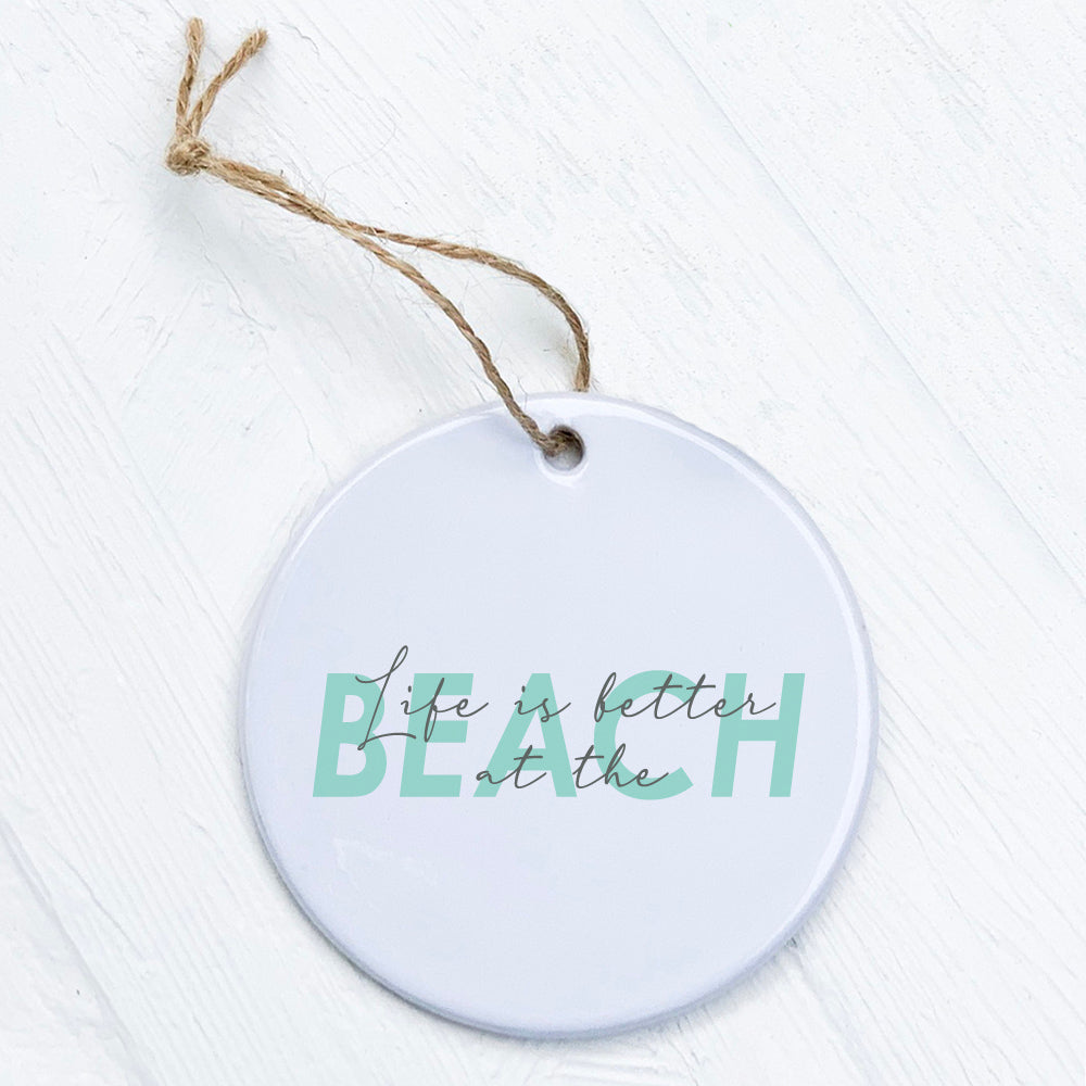 Porcelain ornament featuring 'Life is Better at the Beach' design, showcasing a smooth glossy finish and vibrant colors.