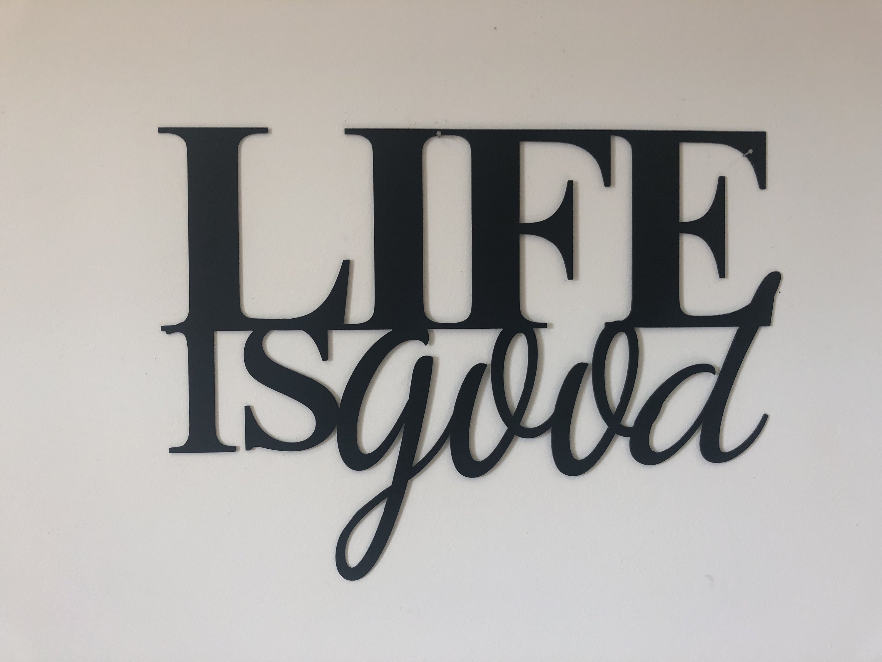 Life Is Good Metal Wall Art Sign in low gloss black finish, measuring 22 inches wide and 16 inches high, perfect for home decor.