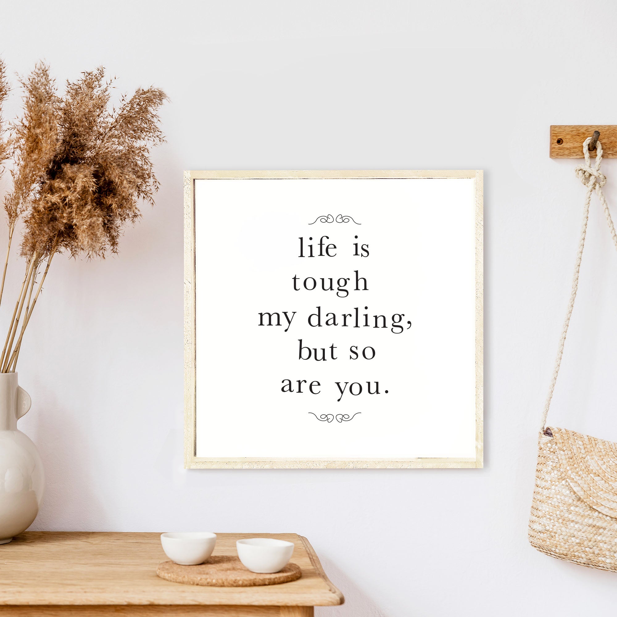 A charming 13x13 inch wood sign with the phrase 'Life Is Tough My Darling' in black text on a white background, framed in stained pine wood.